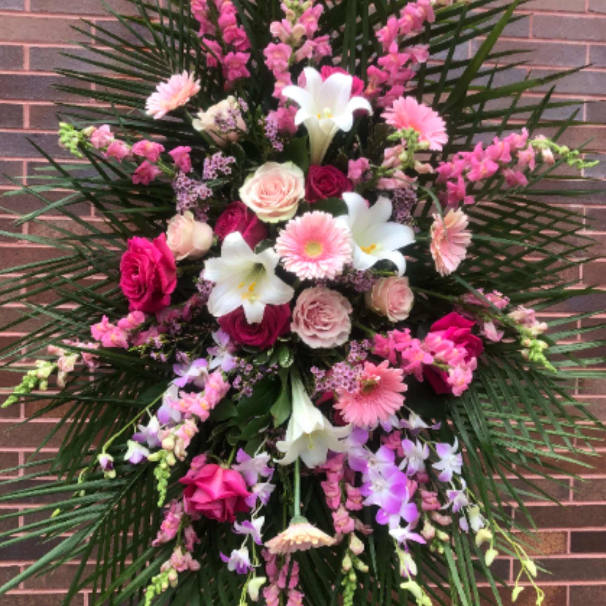 Lilies, Snapdragon, Assorted Roses, Gerbera Daisies, Dendrobium Orchods, Assorted Fancy Greens