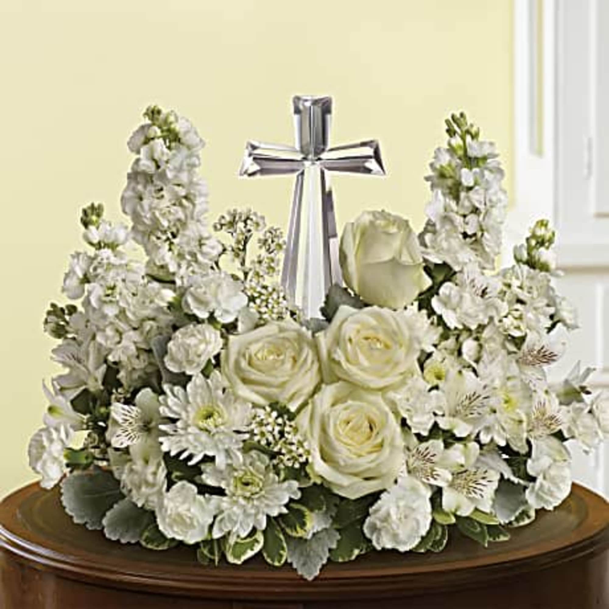 An elegant display of faith and divine peace, this beautiful arrangement will