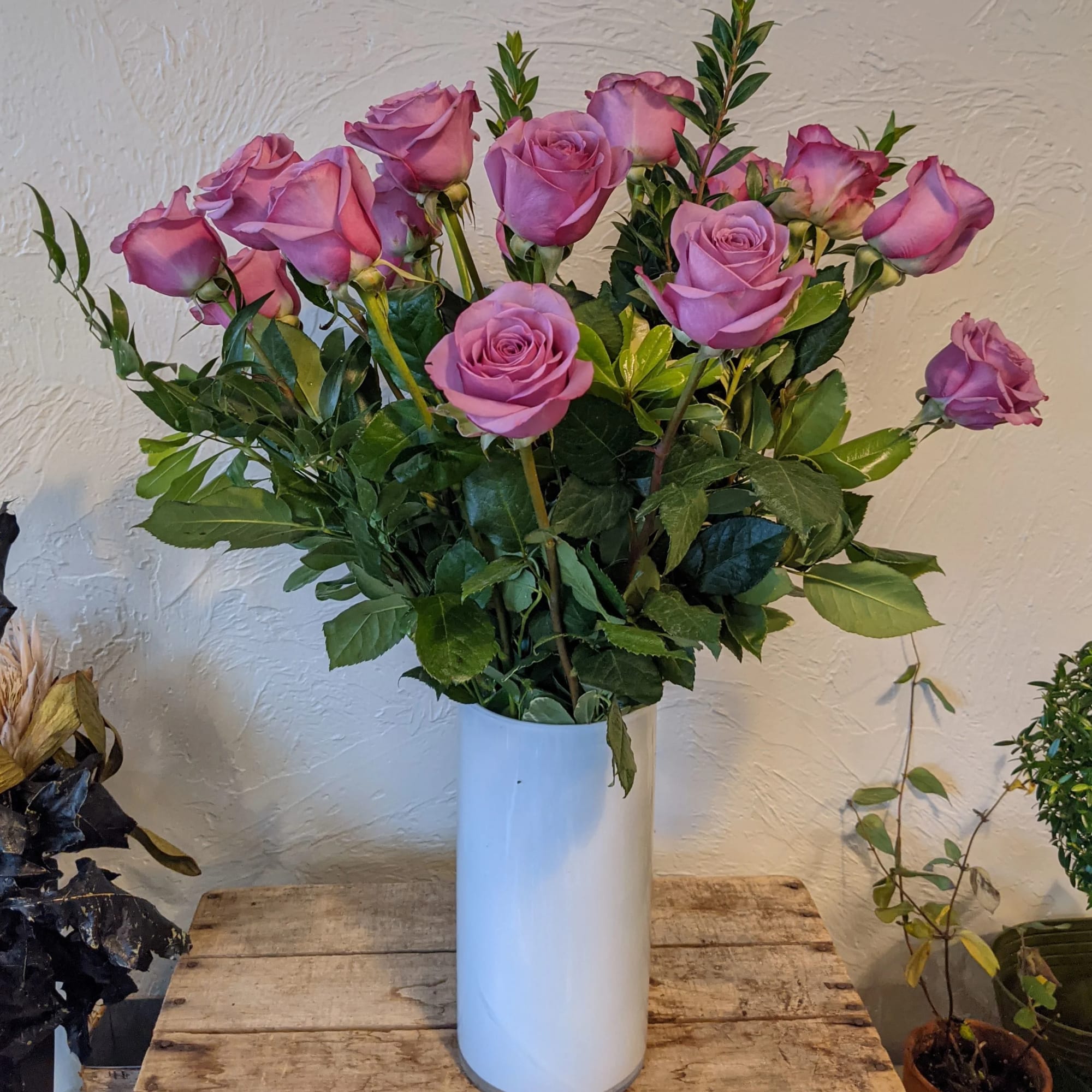 A timeless classic, send a dozen roses in a vase with complementing