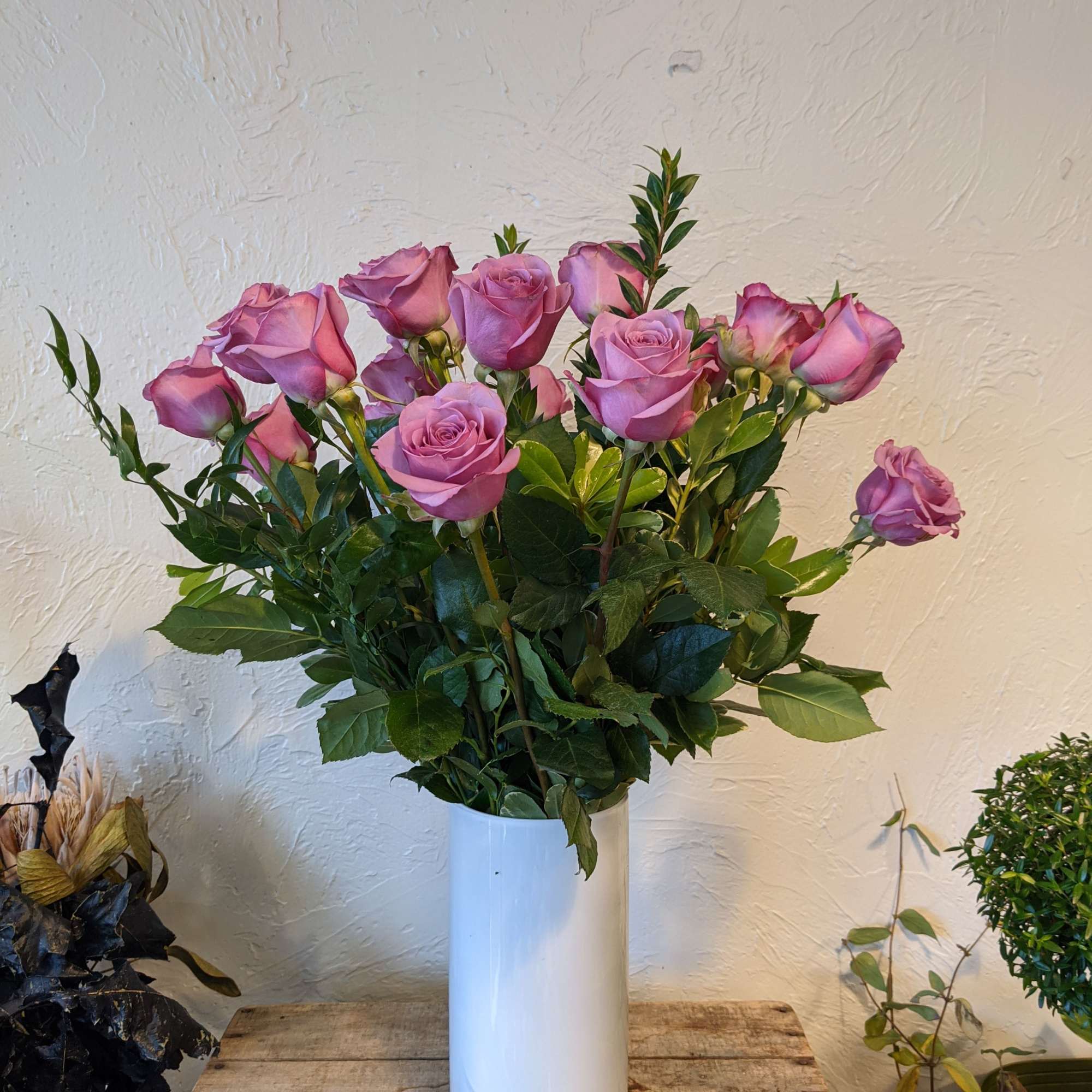 A timeless classic, send a dozen roses in a vase with complementing