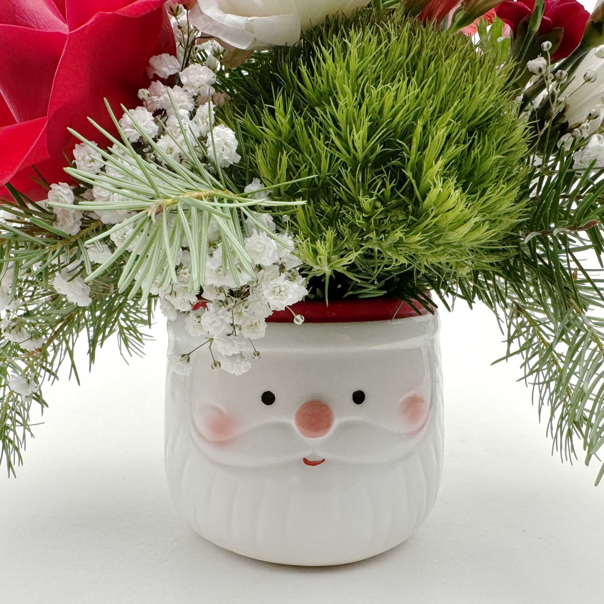 Send some holiday cheer with our Santa Baby flower arrangement. Seasonal premium
