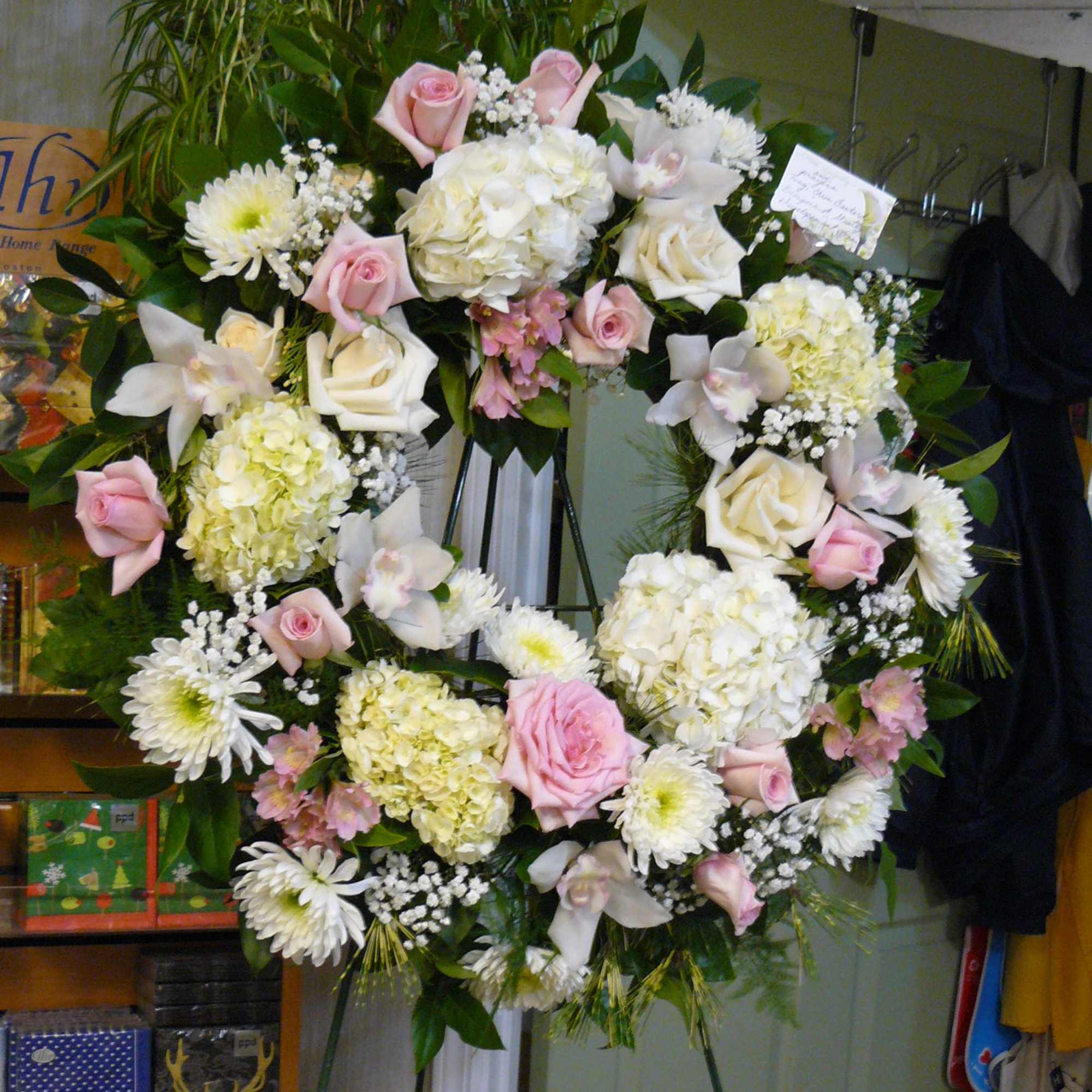 CYMBIDIUM ORCHIDS, PINK ROSES, WHITE ROSES, WHITE HYDRANGEA,
SPIDER MUMS, FANCY ASSORTED GREENS