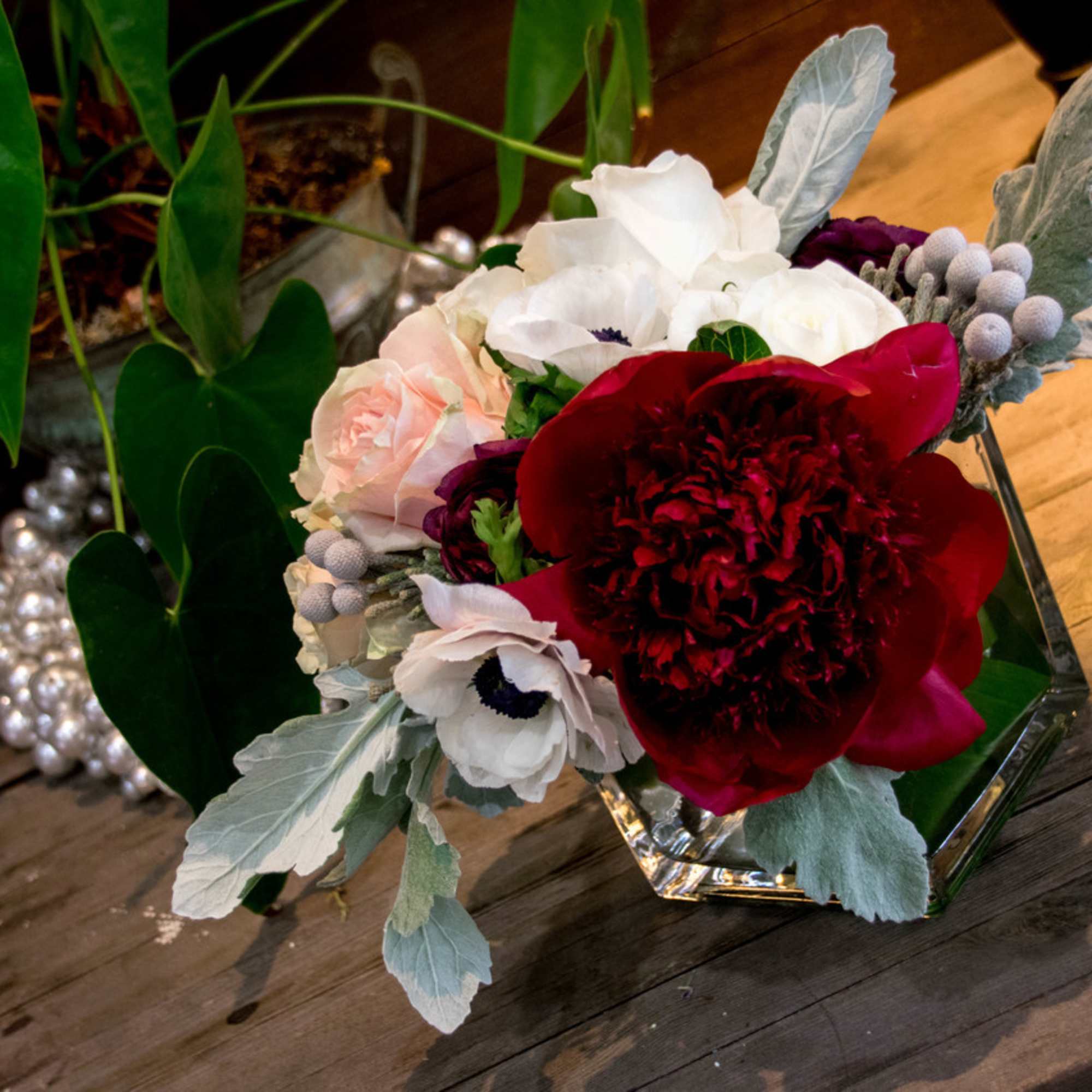 This beauty is designed with soft pink roses, white anemones, dark red