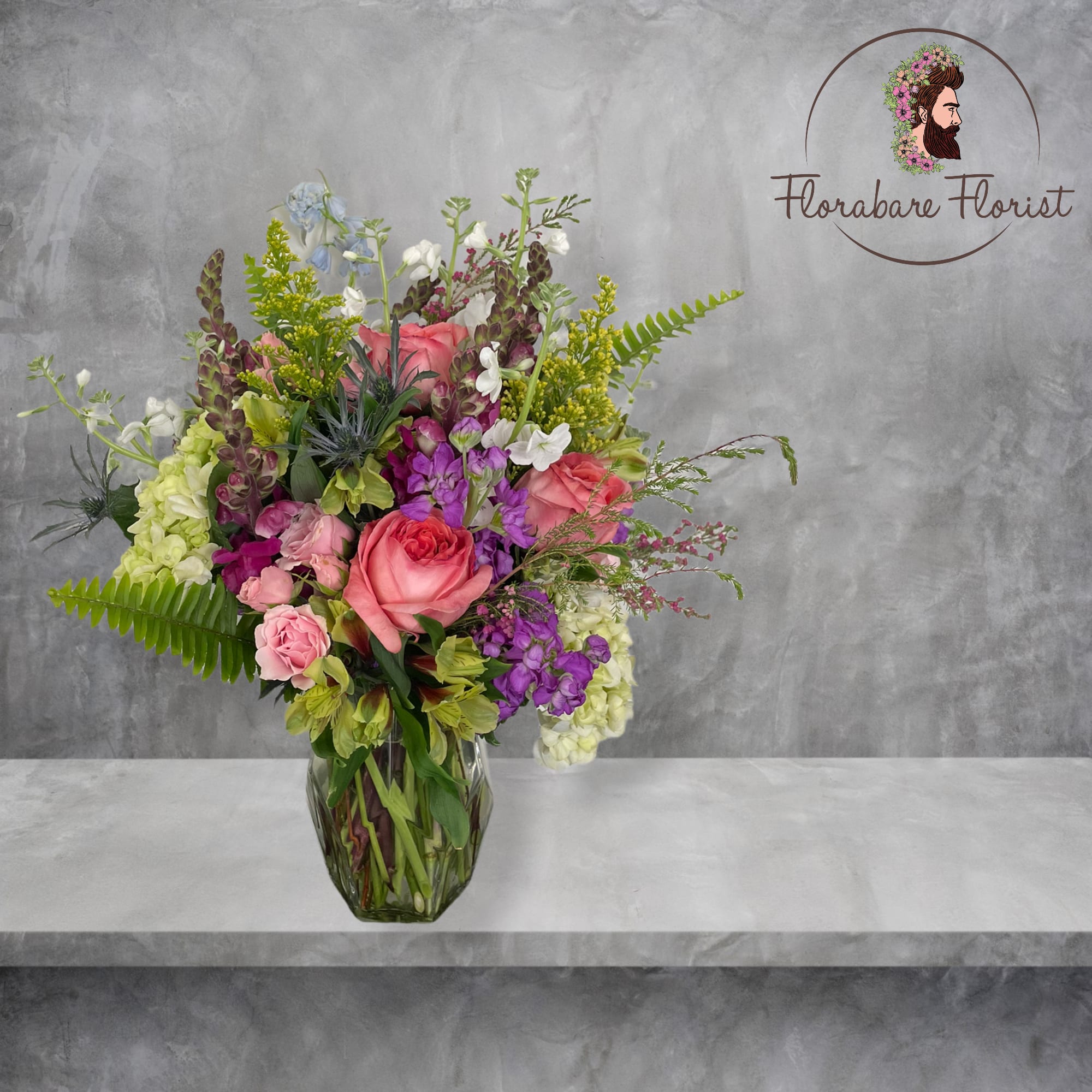 Lush floral design filled with vibrant colors. Consisting of seasonal flowers and