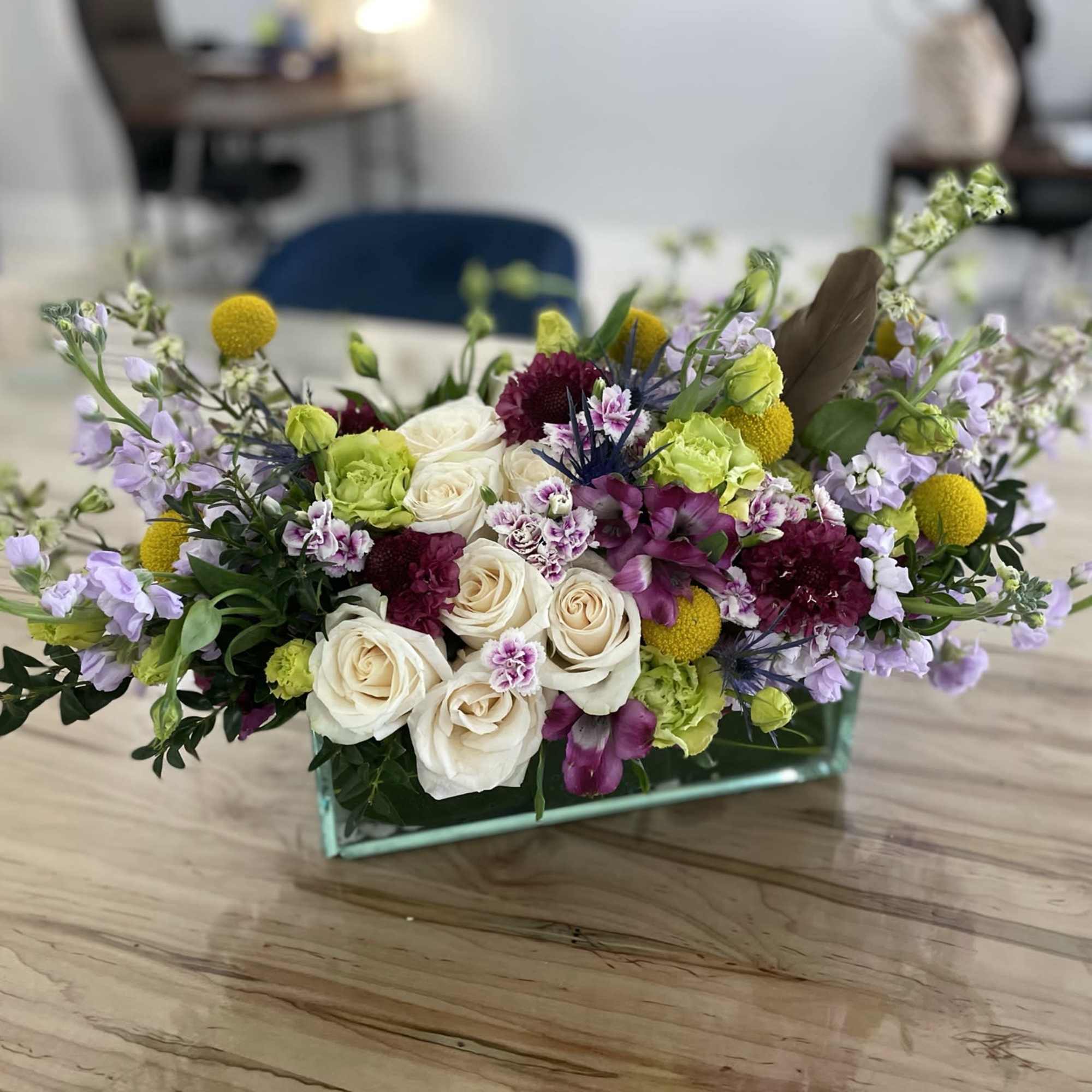 Lush floral design filled with vibrant colors. Consisting of seasonal flowers and