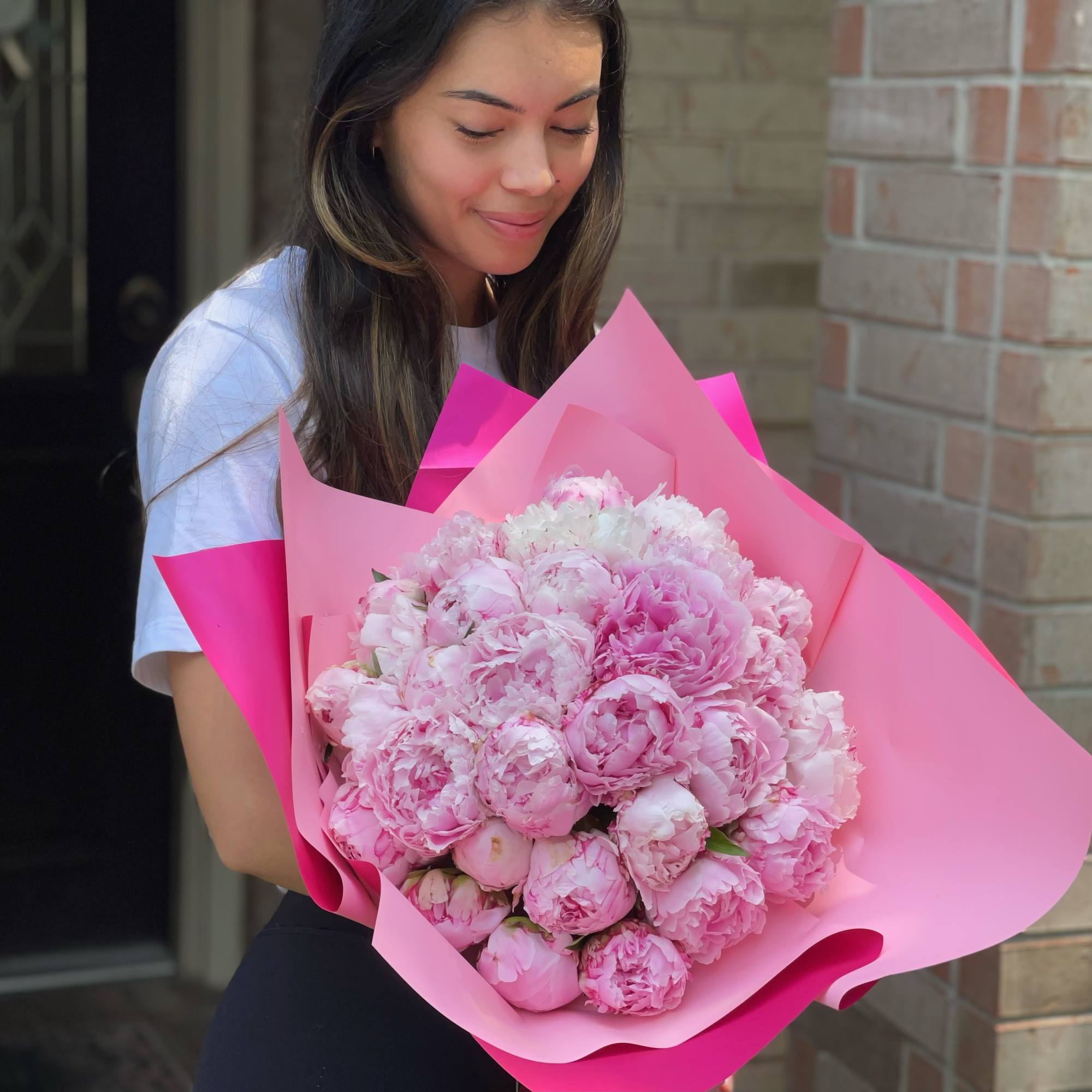 15  peonies in a wrapped bouquet. Please note: The availability most