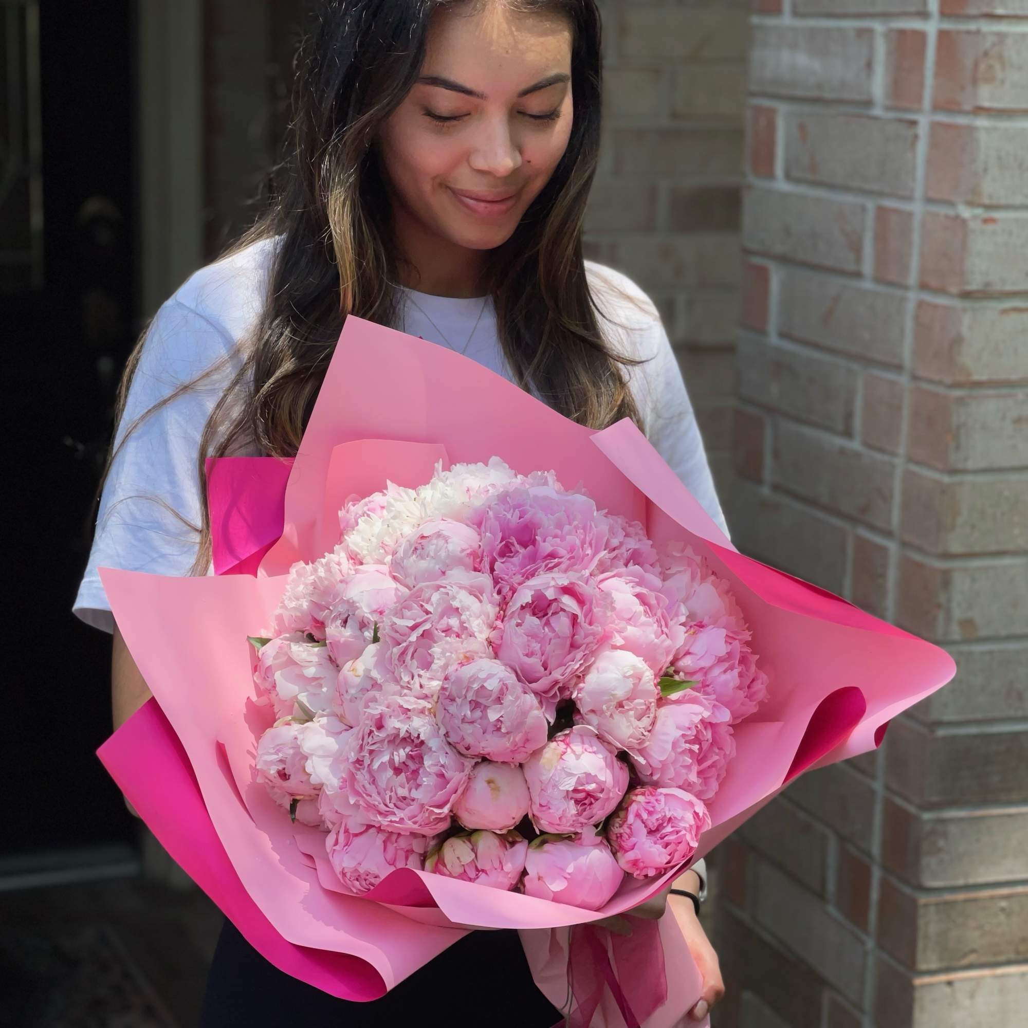 15  peonies in a wrapped bouquet. Please note: The availability most