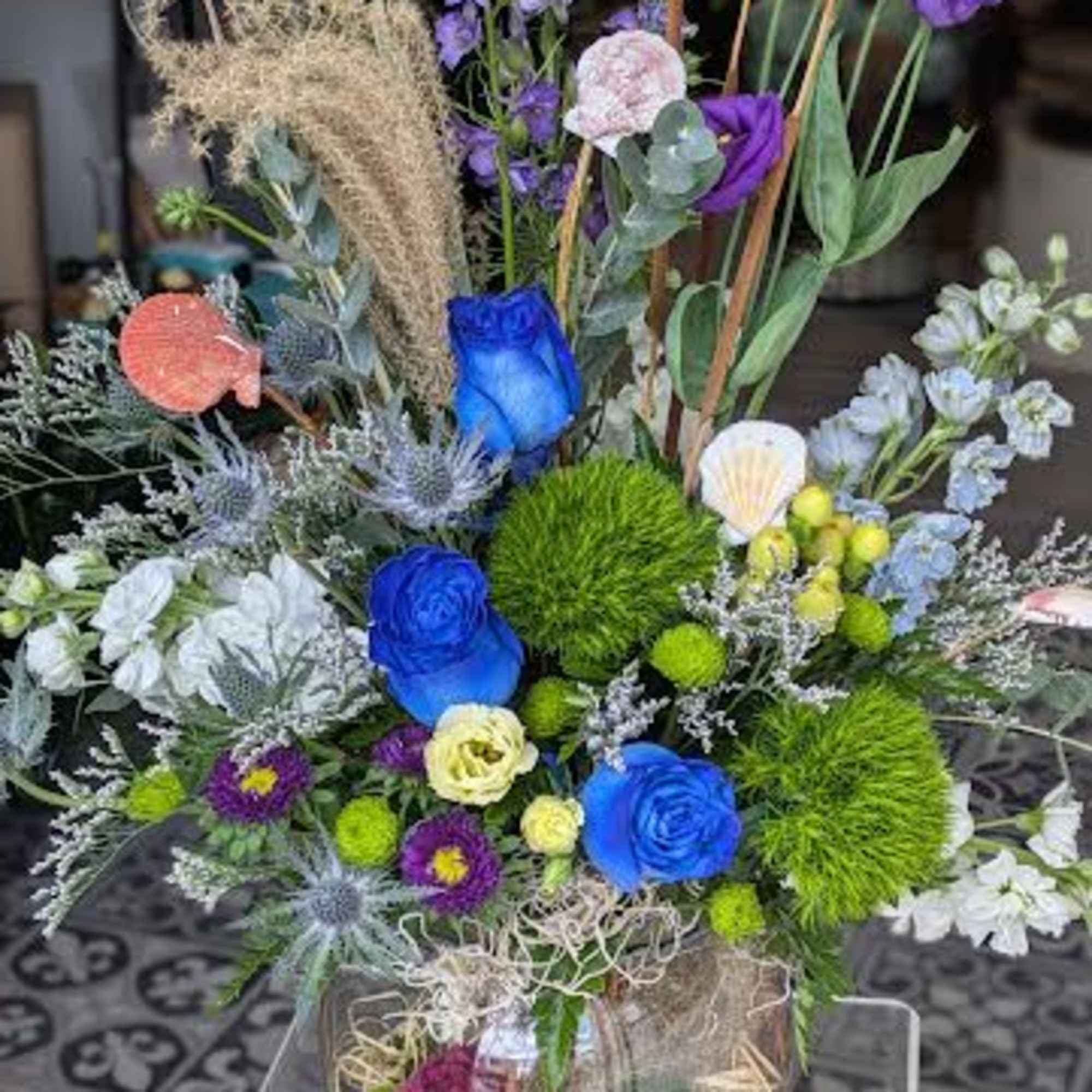 This arrangement is a designer choice. There is no guarantee of flowers