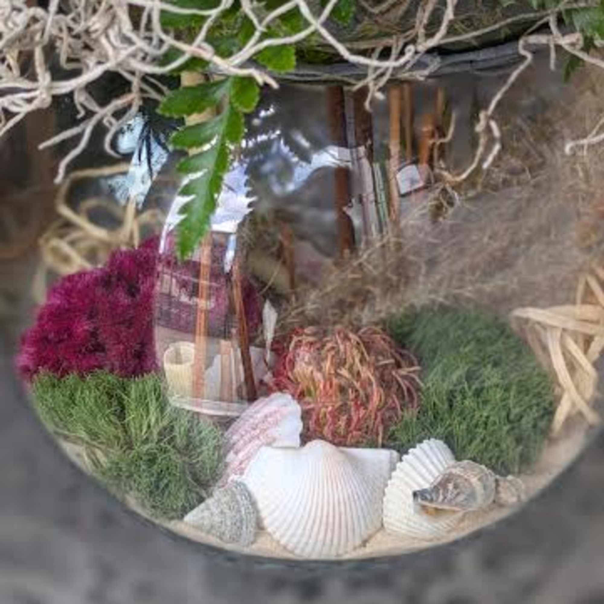 This arrangement is a designer choice. There is no guarantee of flowers