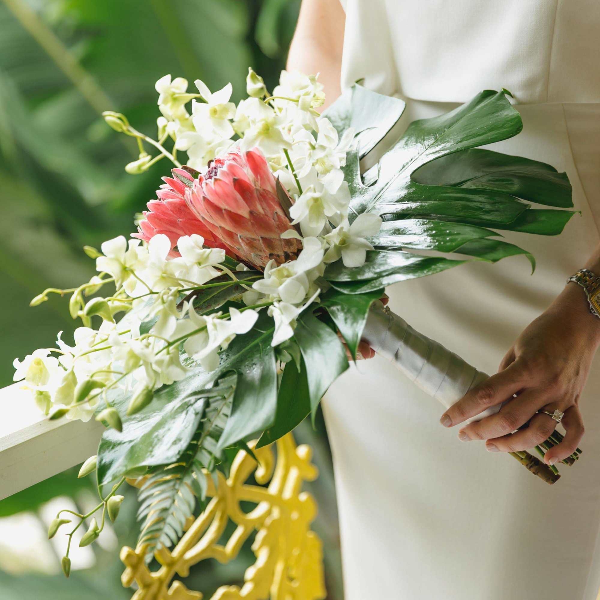 Indulge in the elegance of our Whitney Tropical Wedding Bouquet. Crafted with
