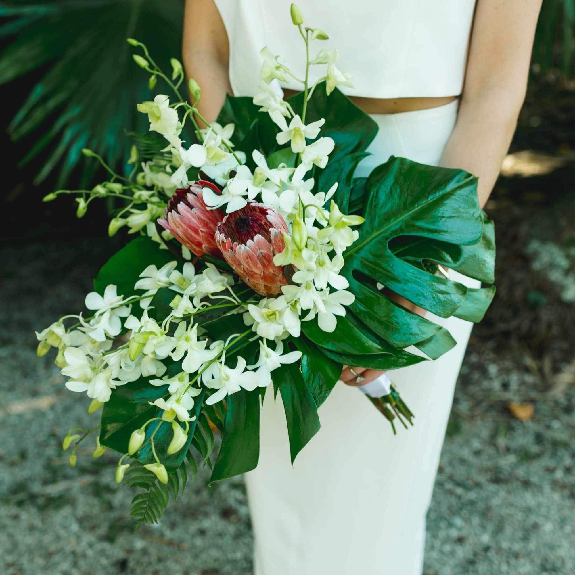 Indulge in the elegance of our Whitney Tropical Wedding Bouquet. Crafted with