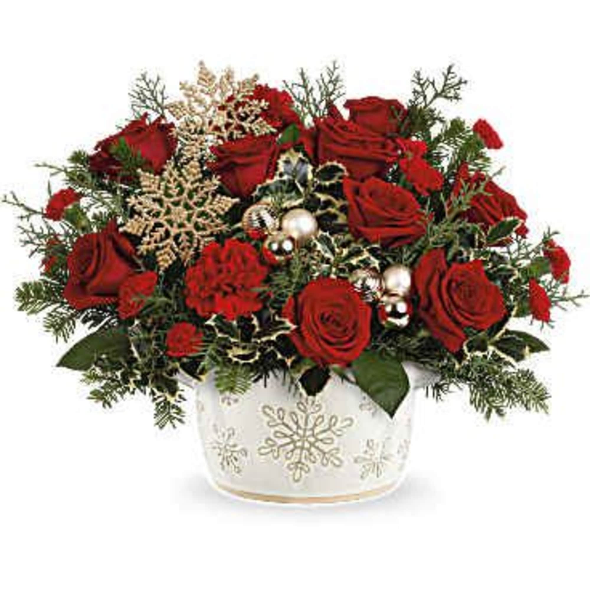 Teleflora&#039;s Snowflake Symphony Centerpiece features vibrant red roses, classic red carnations, and