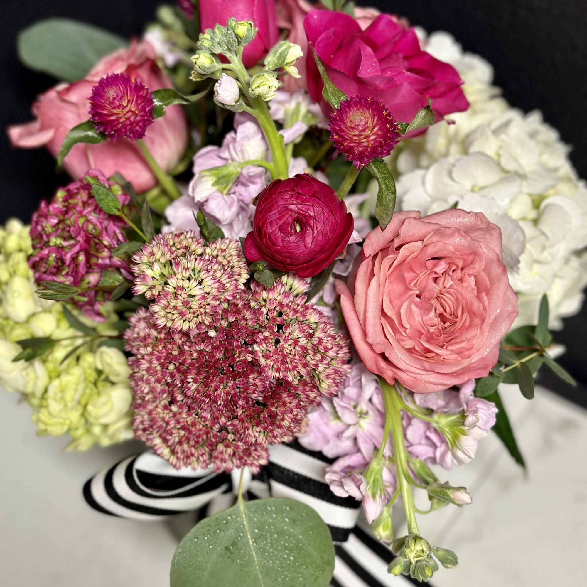 A pretty seasonal mix in shades of pink, arranged low and dense