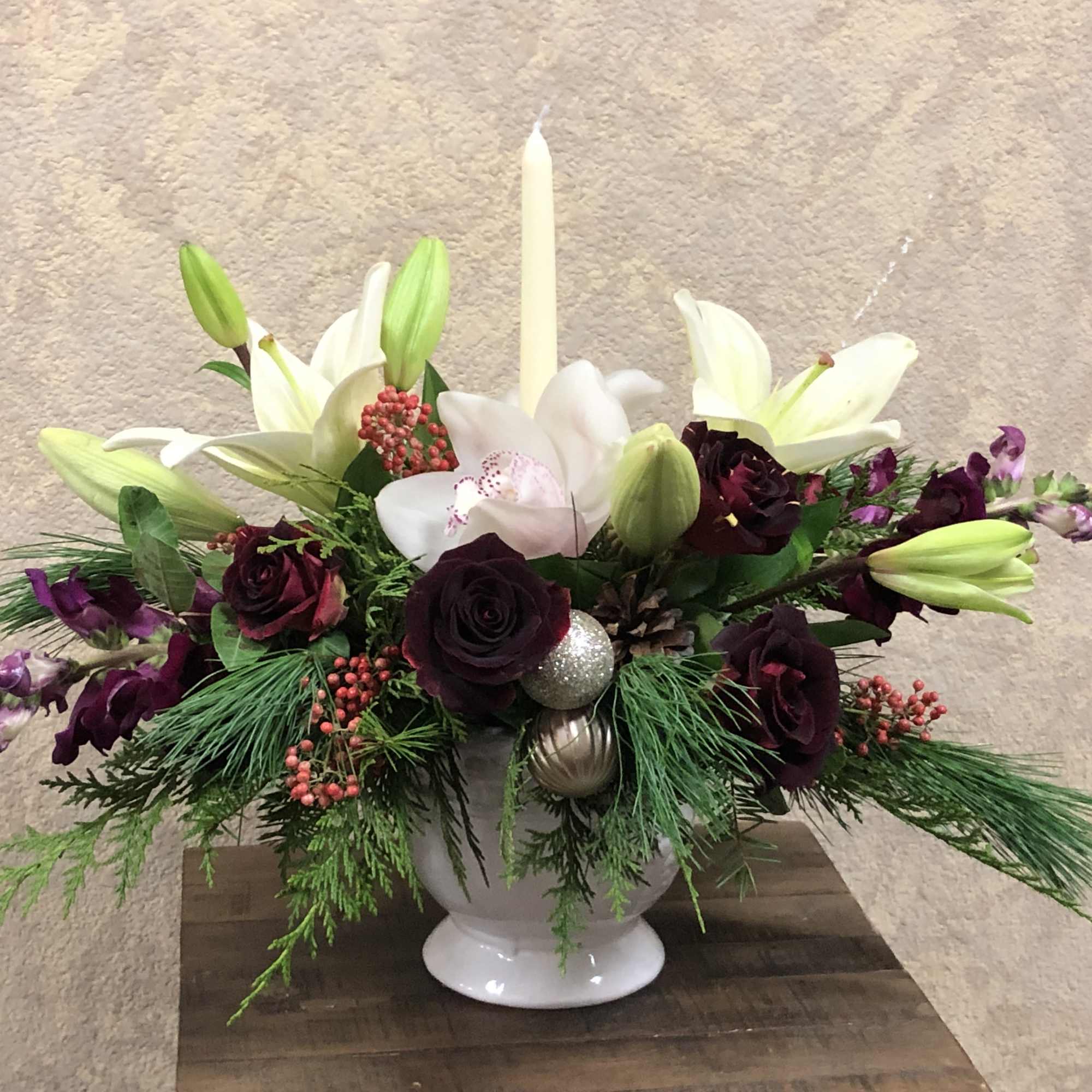 Christmas centerpiece with white orchids, white lillies, red roses purple cymbidium orchids