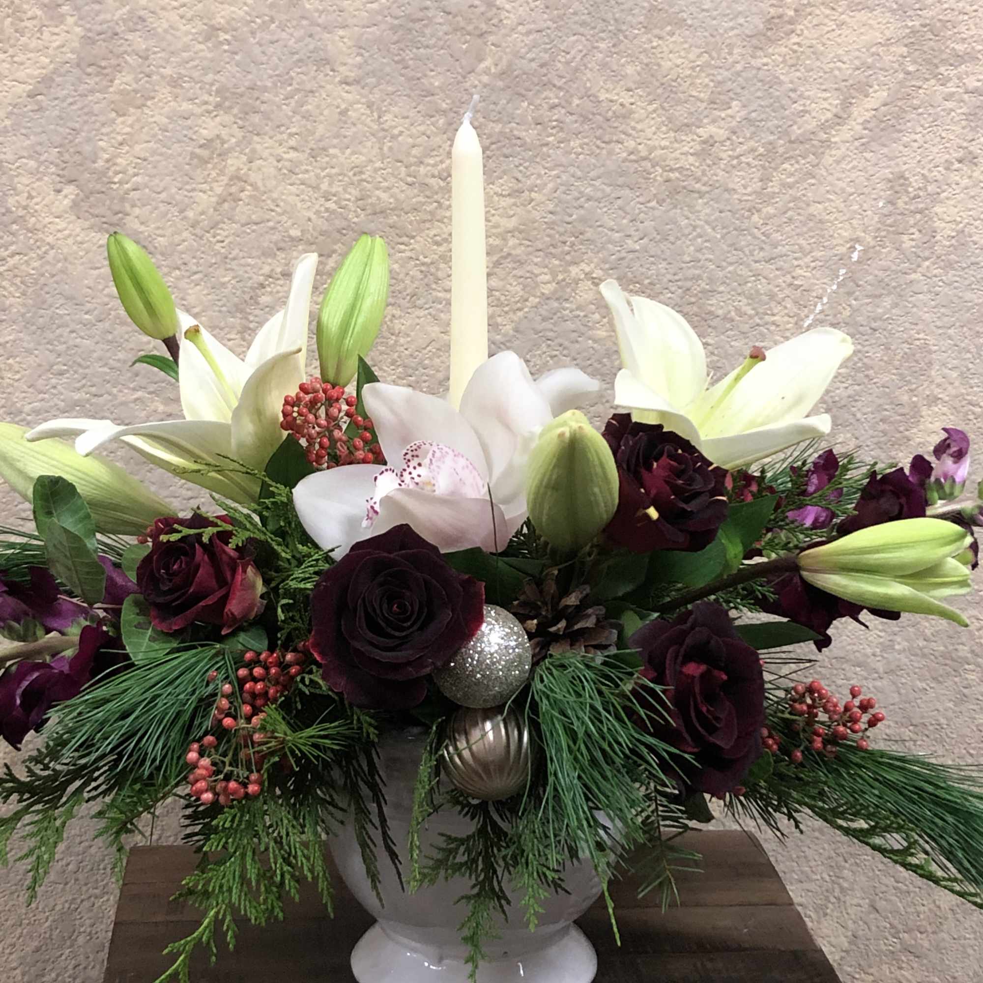 Christmas centerpiece with white orchids, white lillies, red roses purple cymbidium orchids