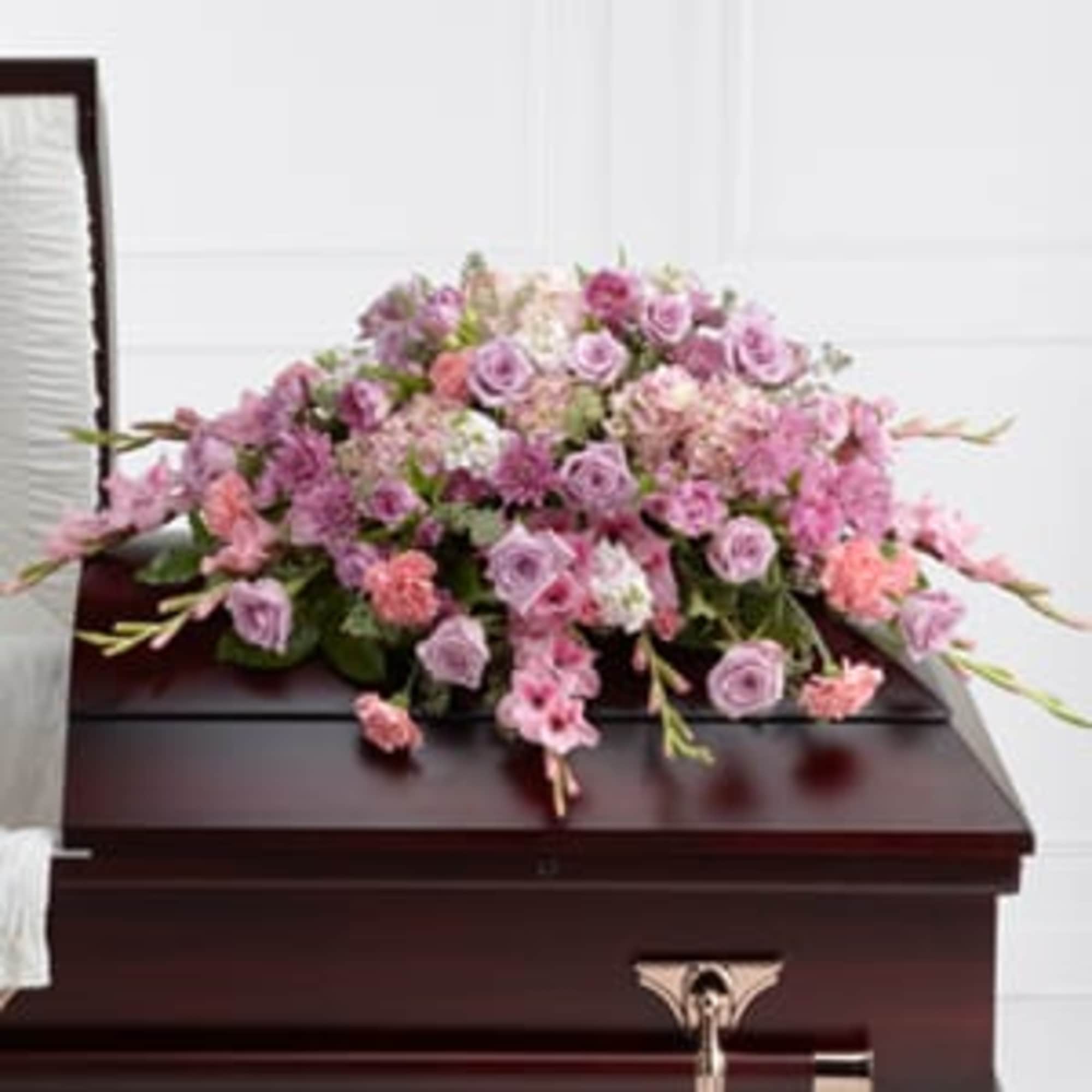 The FTD; Immorata; Casket Spray offers soft beauty and blushing comfort to