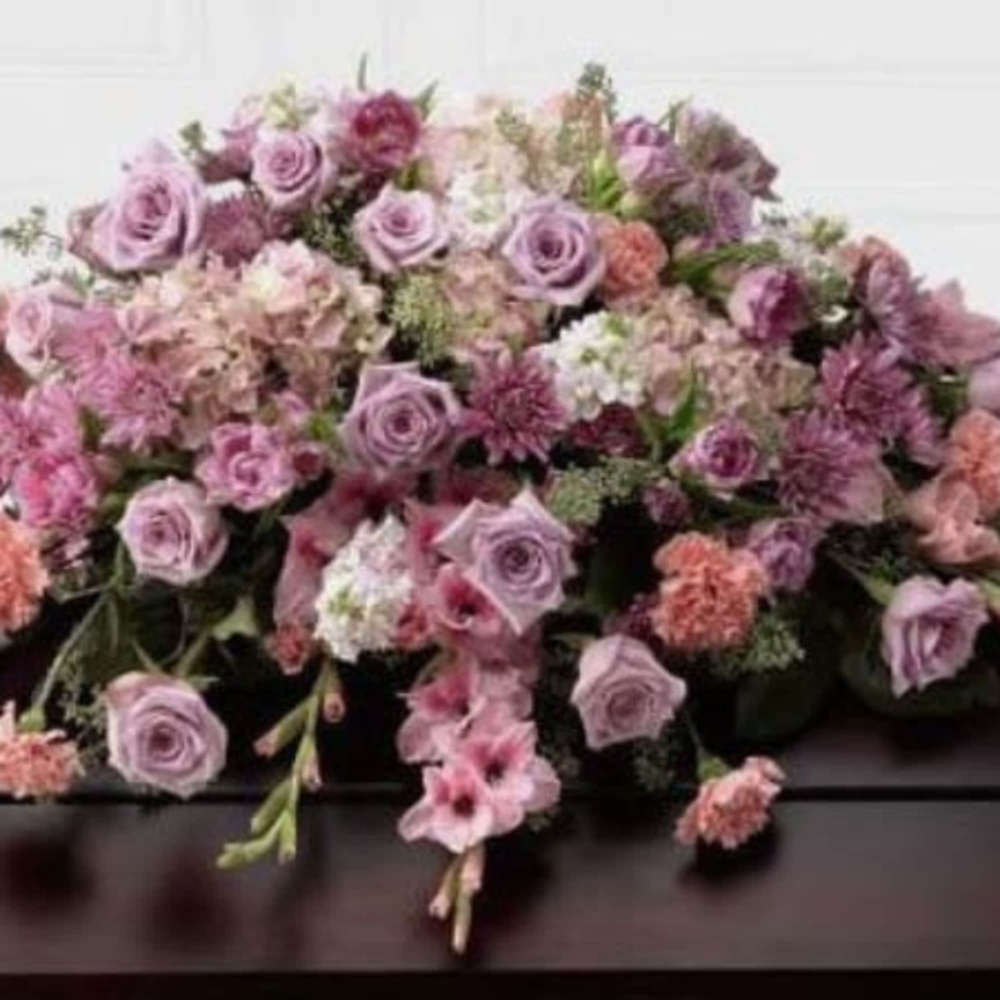 The FTD; Immorata; Casket Spray offers soft beauty and blushing comfort to