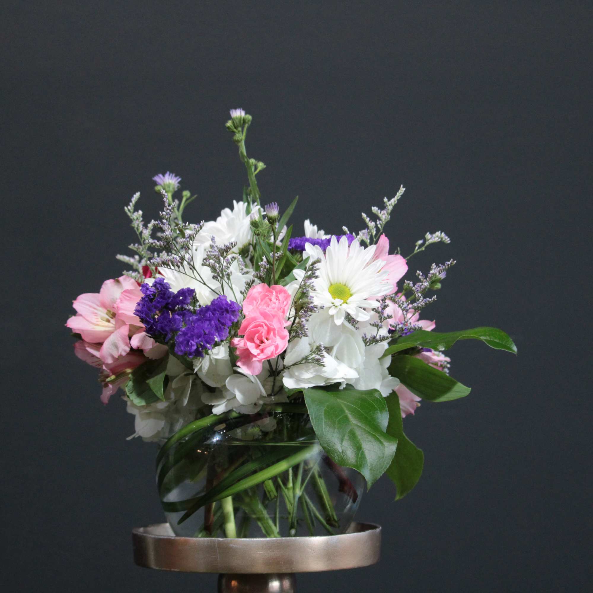 An airy free flowing arrangement full of spring color and life! 