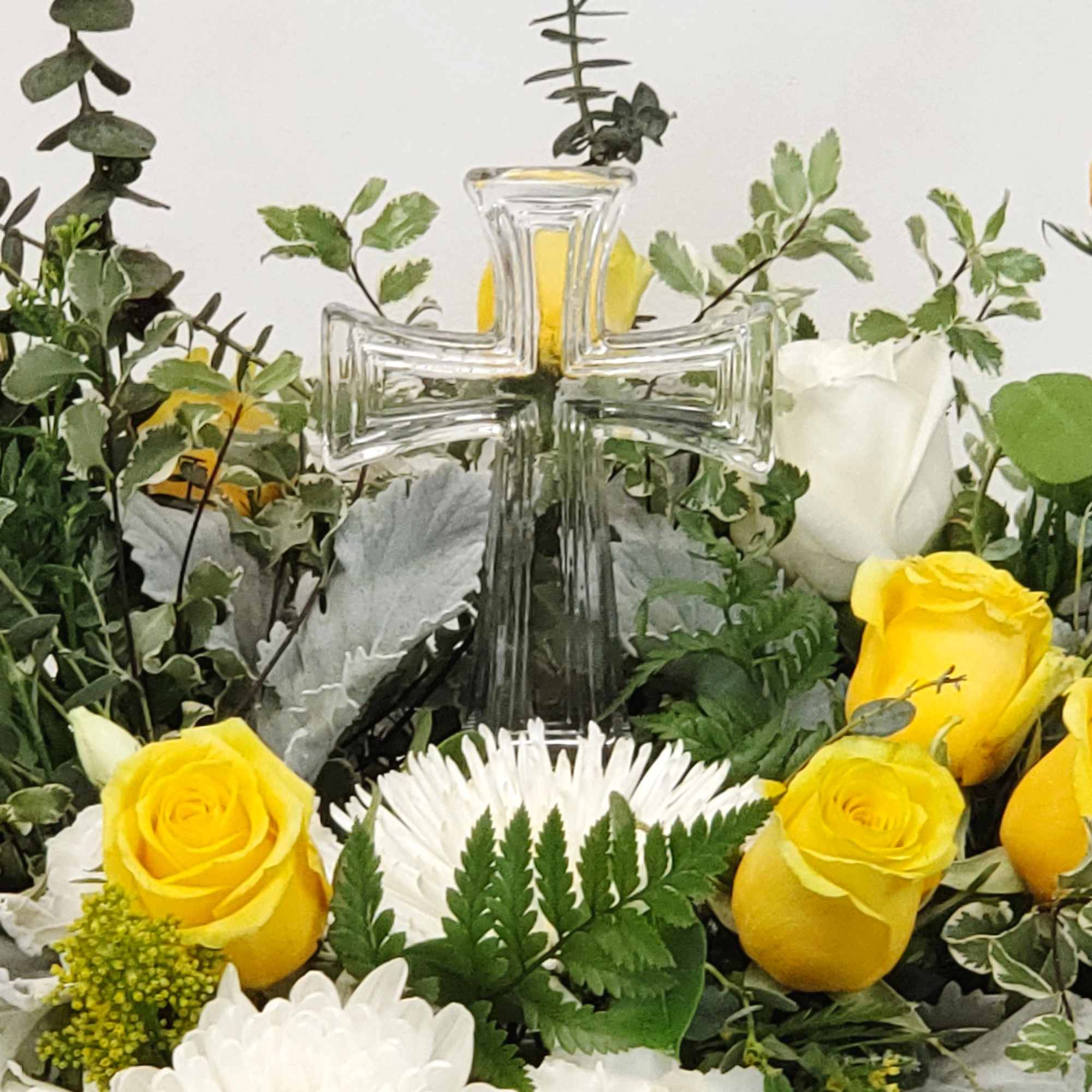 A soft and gentle wreath spray in white and yellow with clear