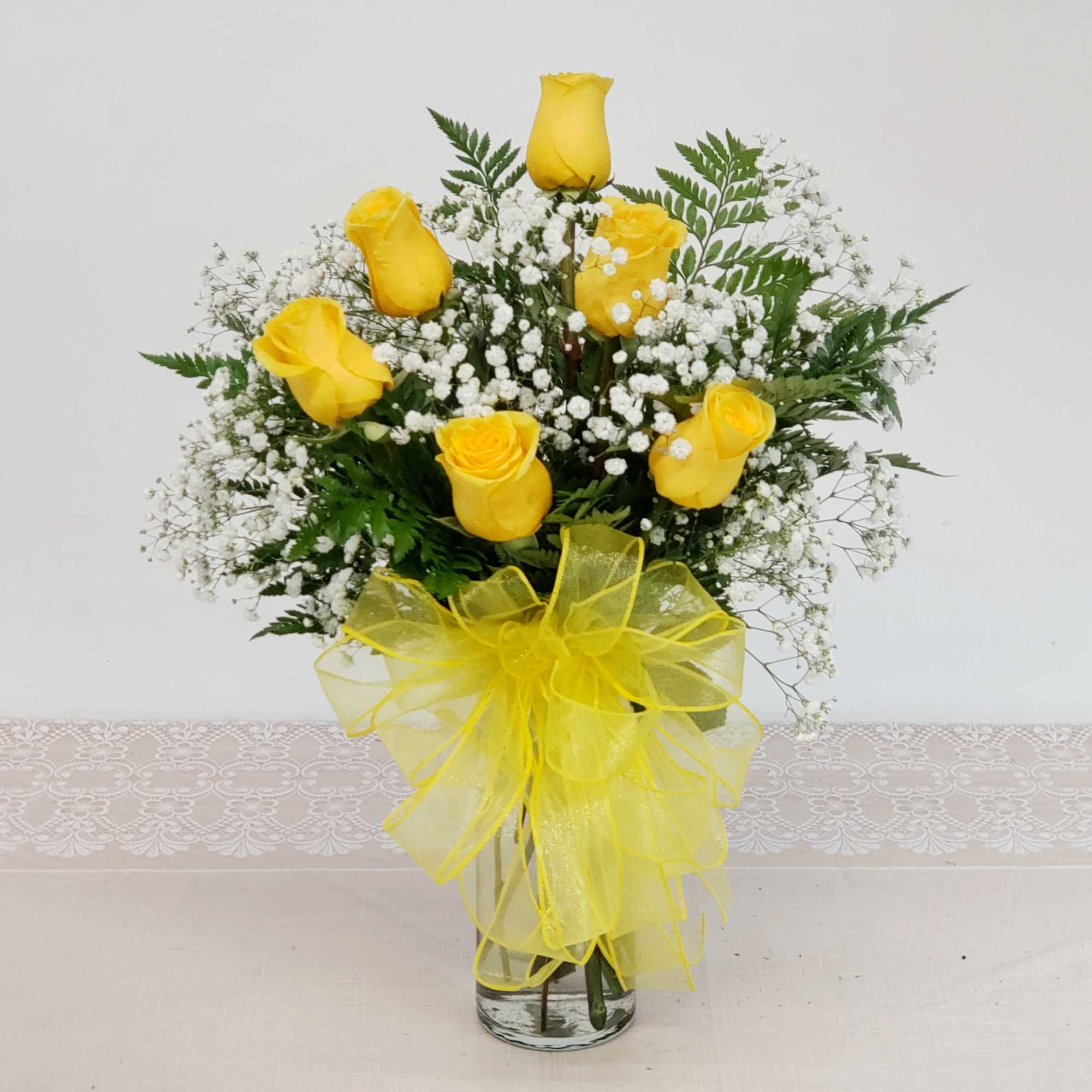 Three yellow roses in a stylish bud vase. Makes a great gift