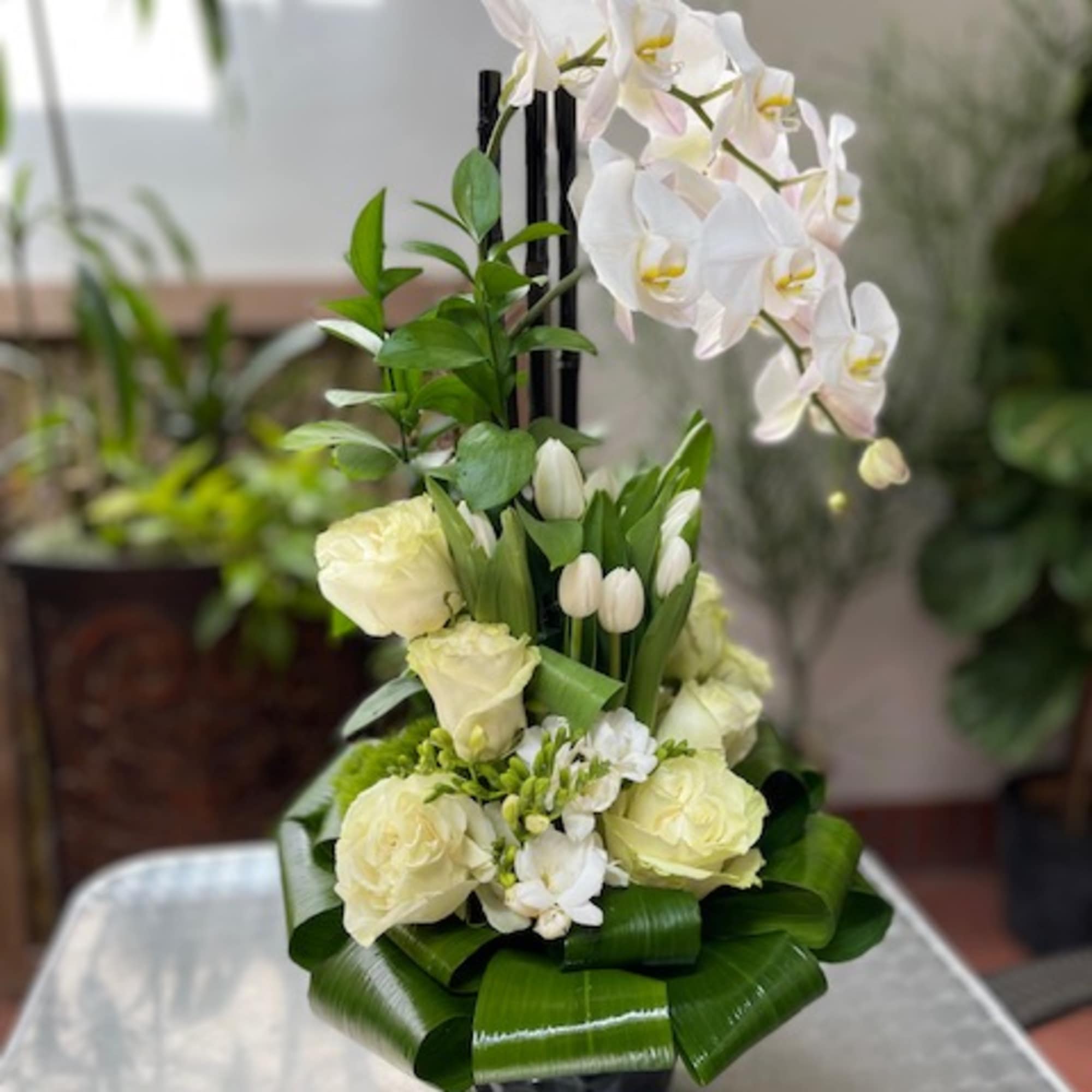 The Ch&eacute;rie Orchids and Tulip Arrangement is a striking display of elegance