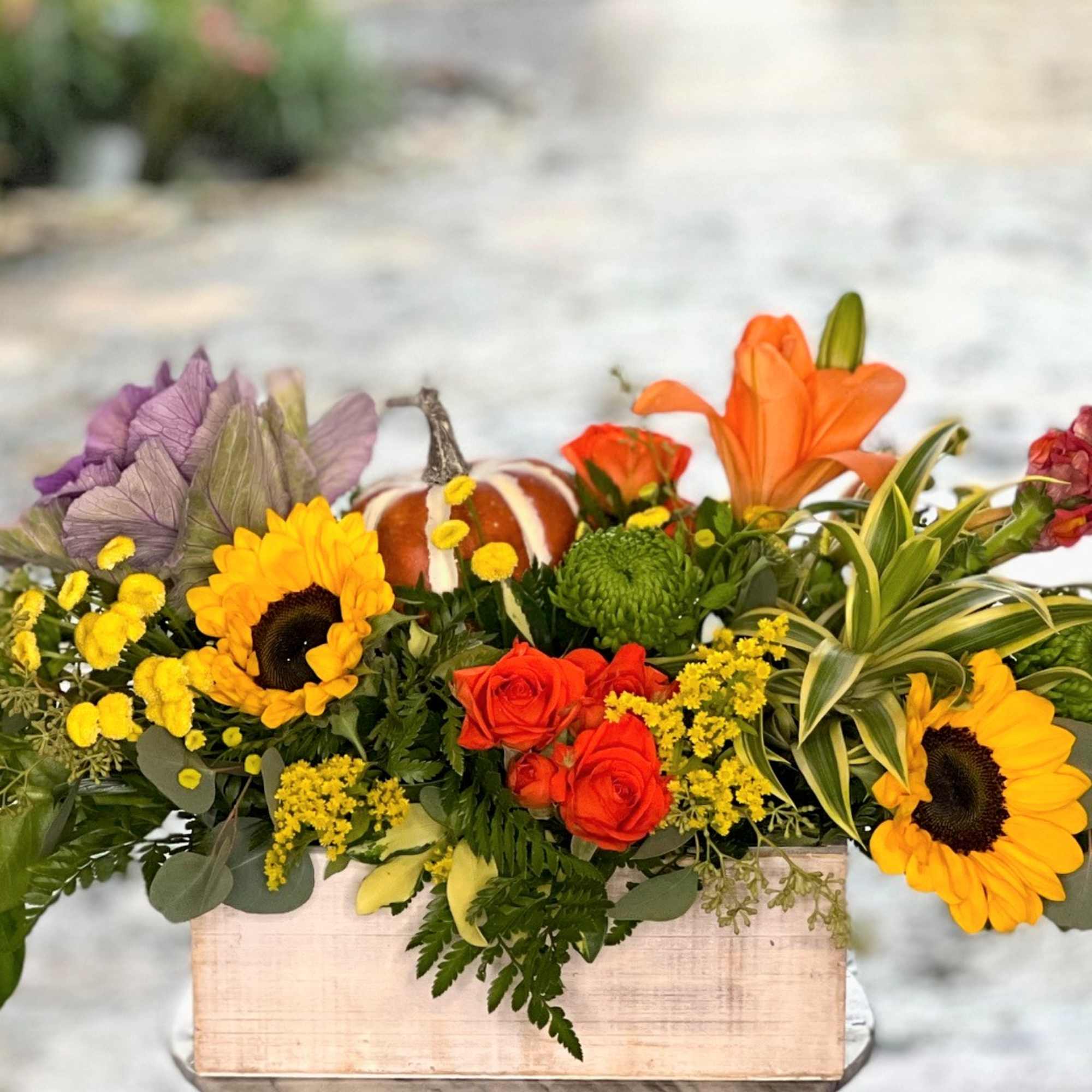 A gorgeous mix of sunflowers, mini garden roses and other fresh flowers