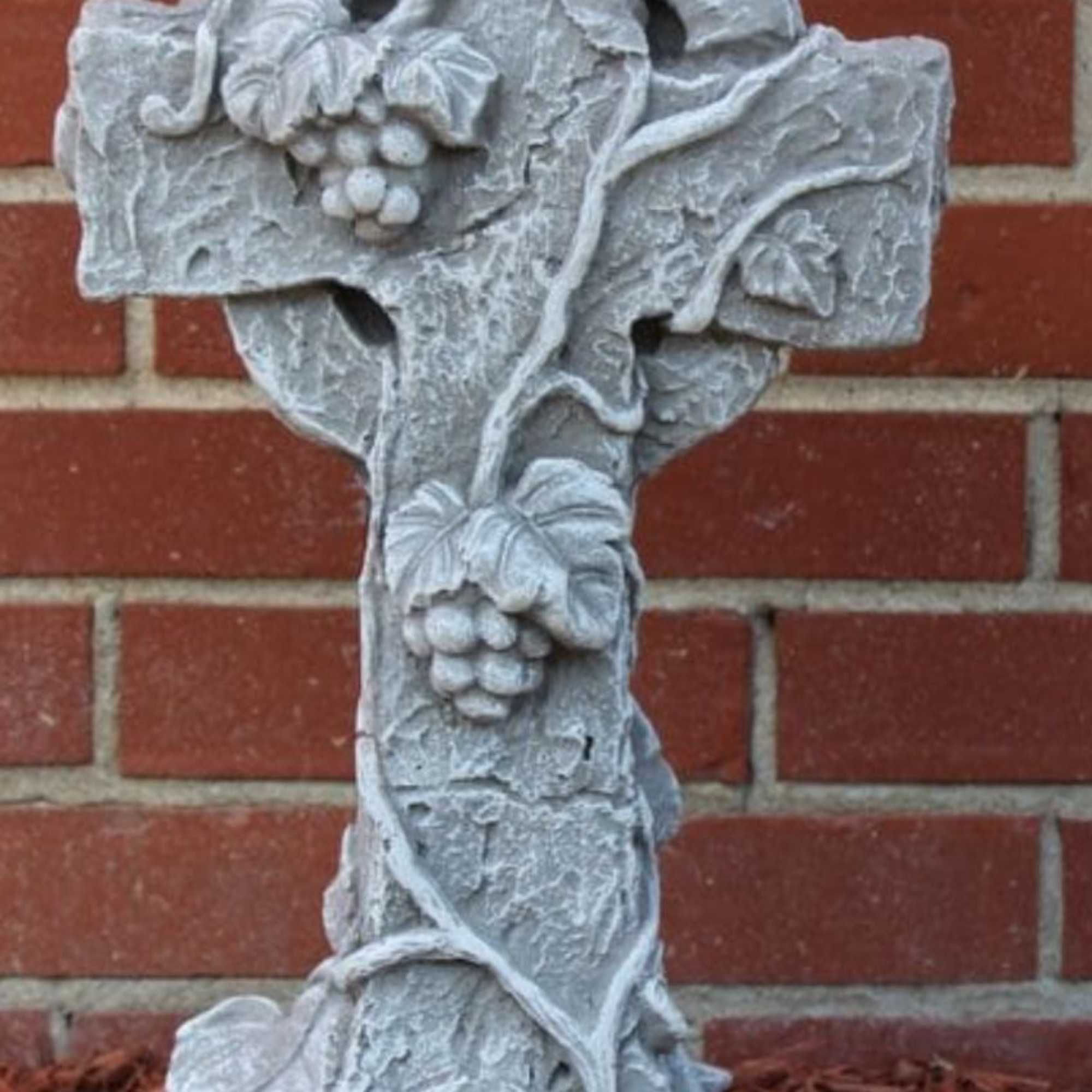 A lovely cross with vines to decorate a yard.