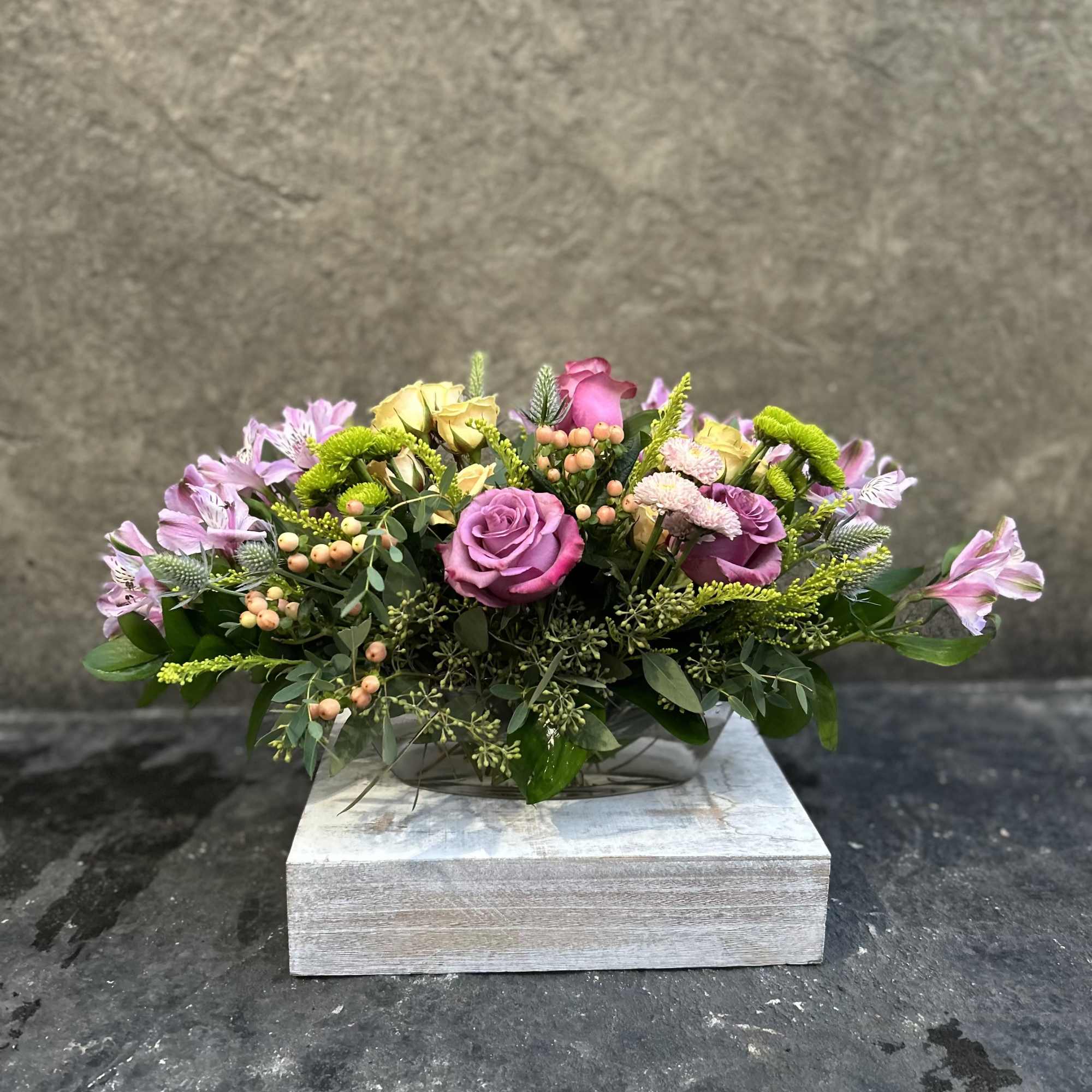 Small glass dish boat with Alstroemeria, berries, buttons, sprays roses and Roses