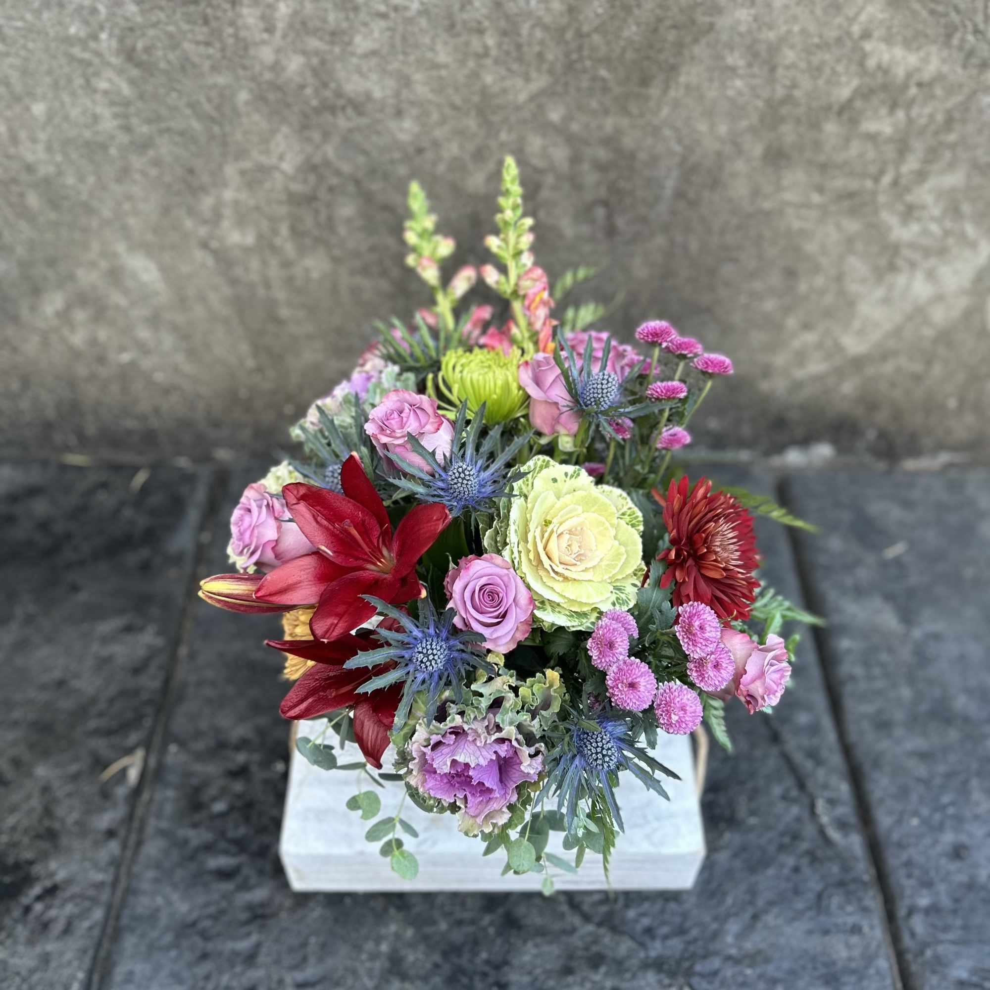 Decorative Kale , burgundy asiatic Lillies, chrysanthemums, lavender roses, snapdragons, eryngium, button