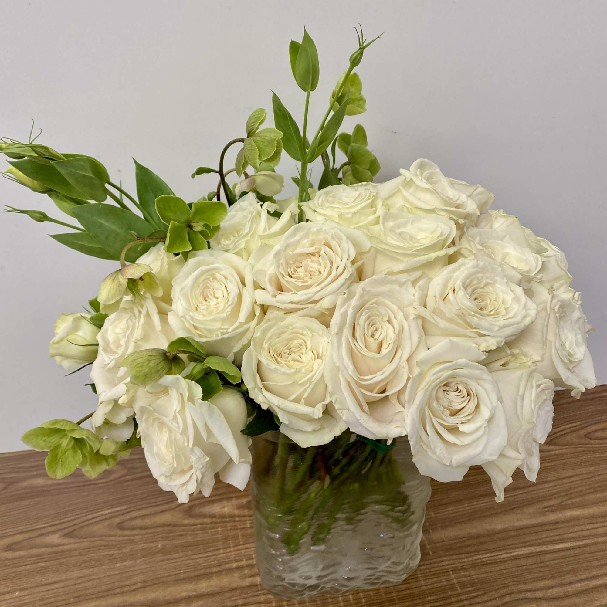 15 white roses in a gold vase 