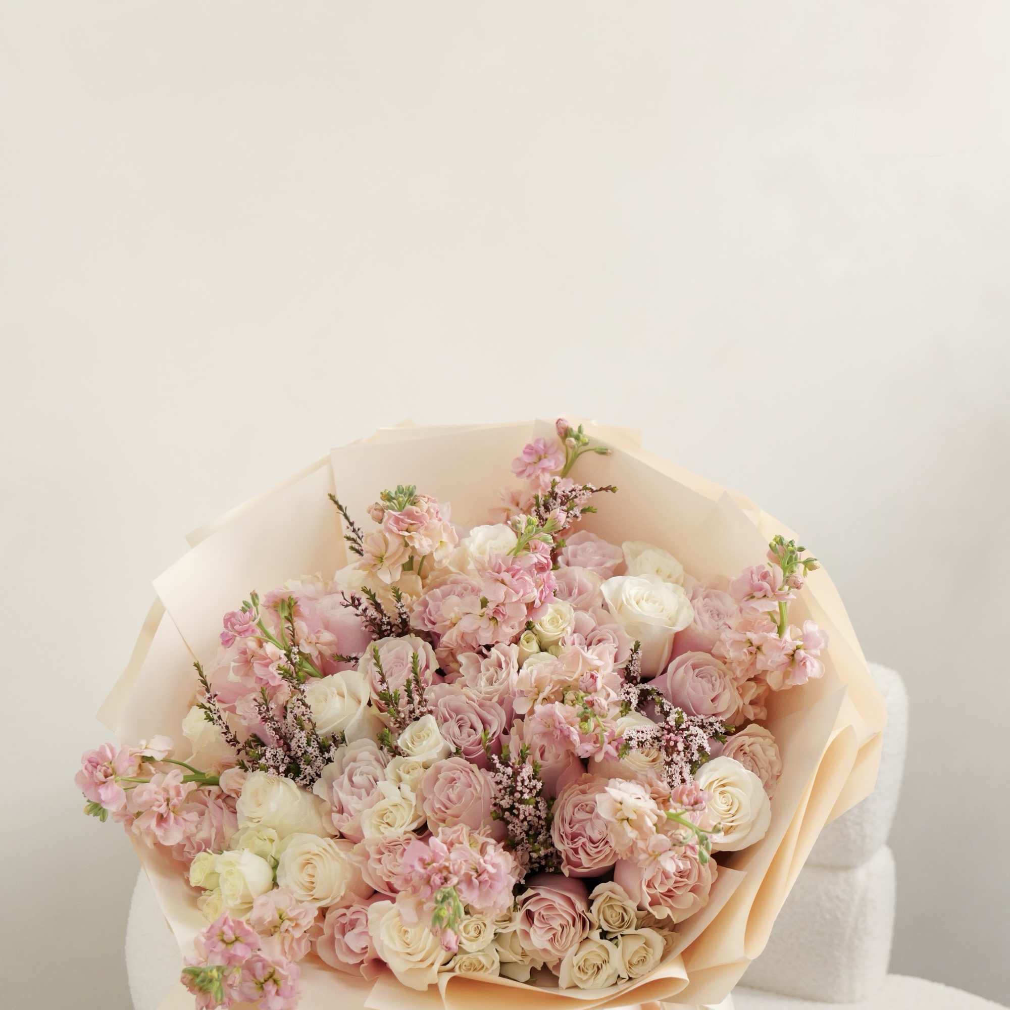 A timeless blend of soft pink and ivory blooms, beautifully wrapped in