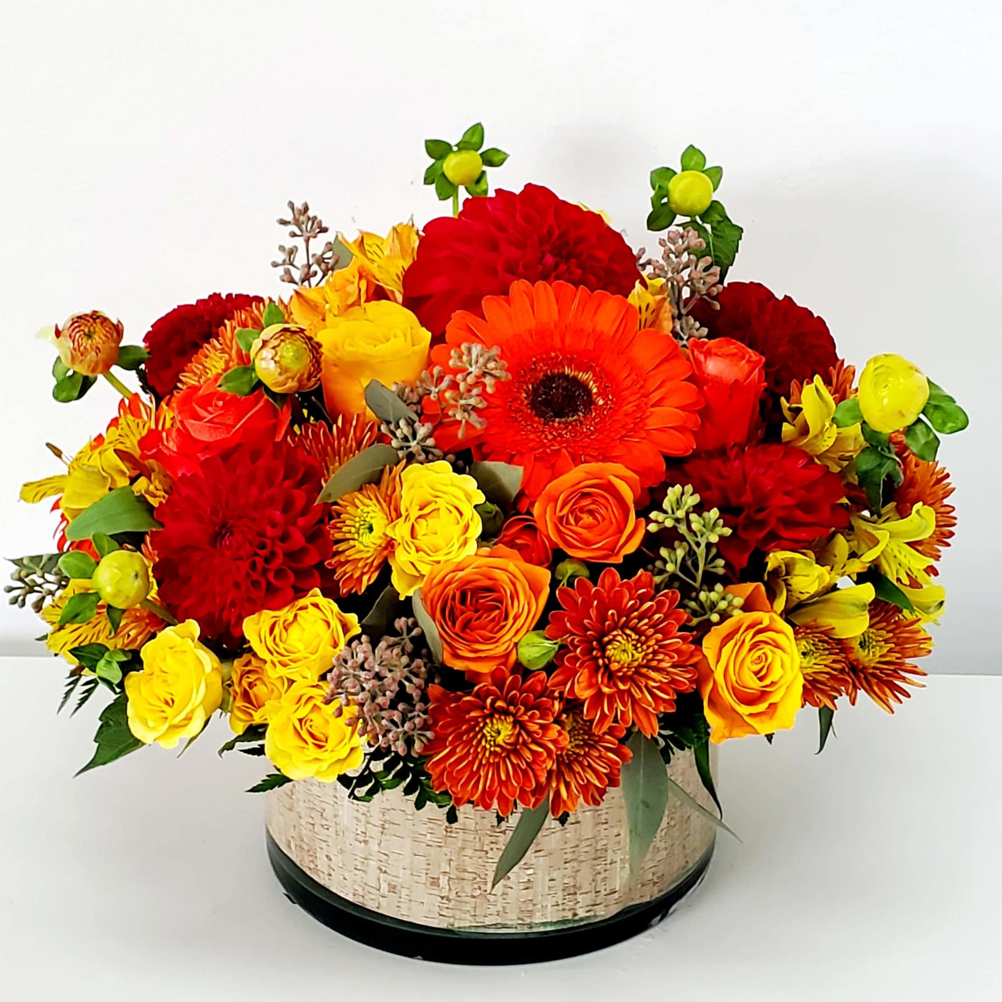 This striking centerpiece captures the warmth of autumn. It features an array