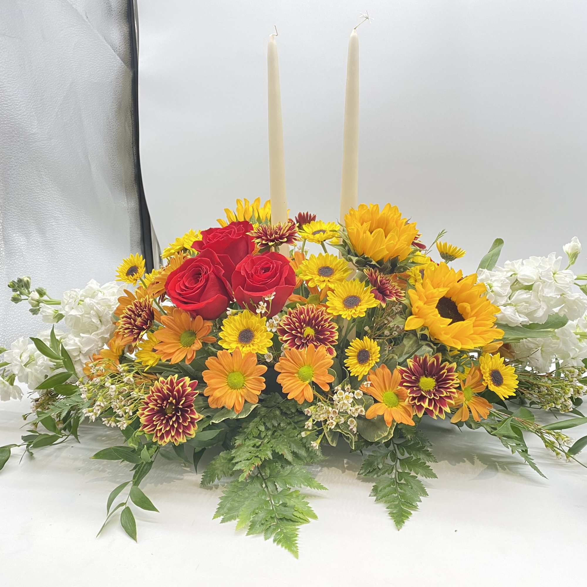 A seasonal centerpiece with yellow hues to wow the recipient...