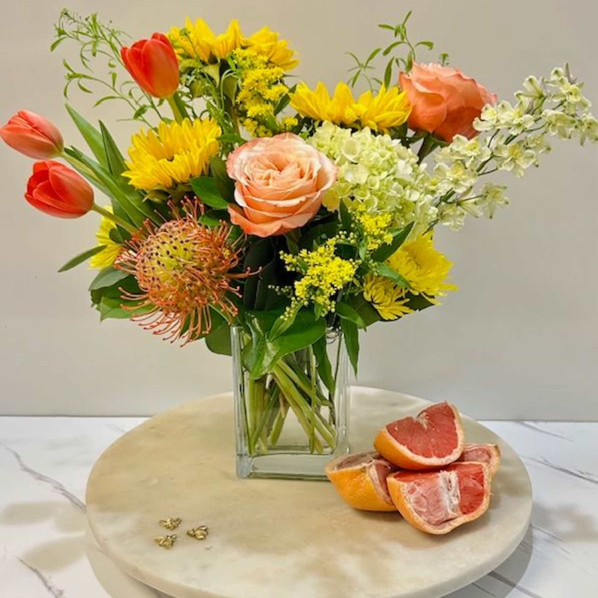 A burst of vibrant energy and warmth, this arrangement captures the refreshing