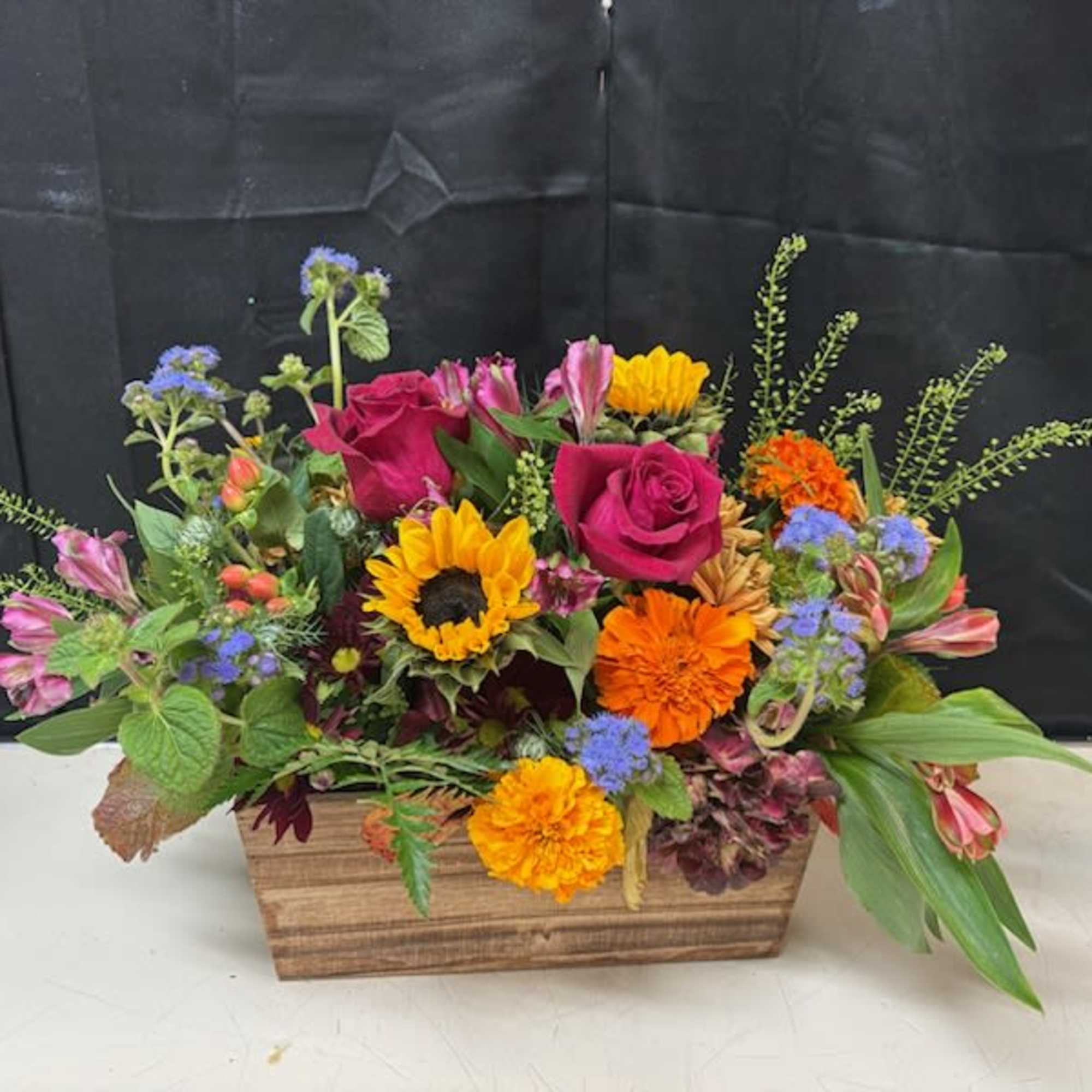 Seasonal blooms in a beautiful wood box created for your Thanksgiving feast!