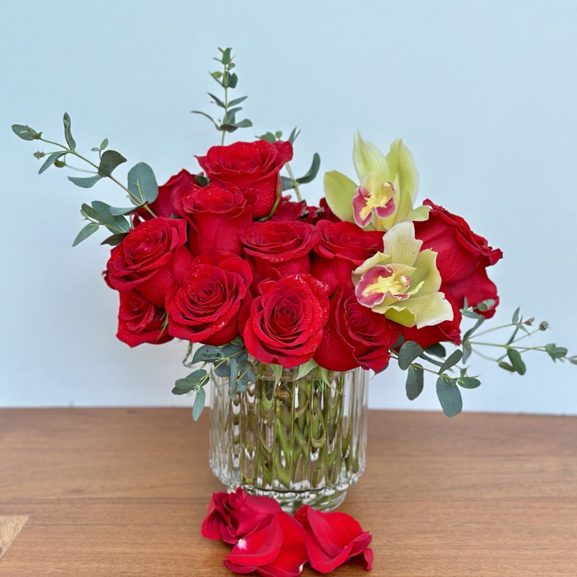 Craft a romantic gift with 25 premium red roses accented by vibrant