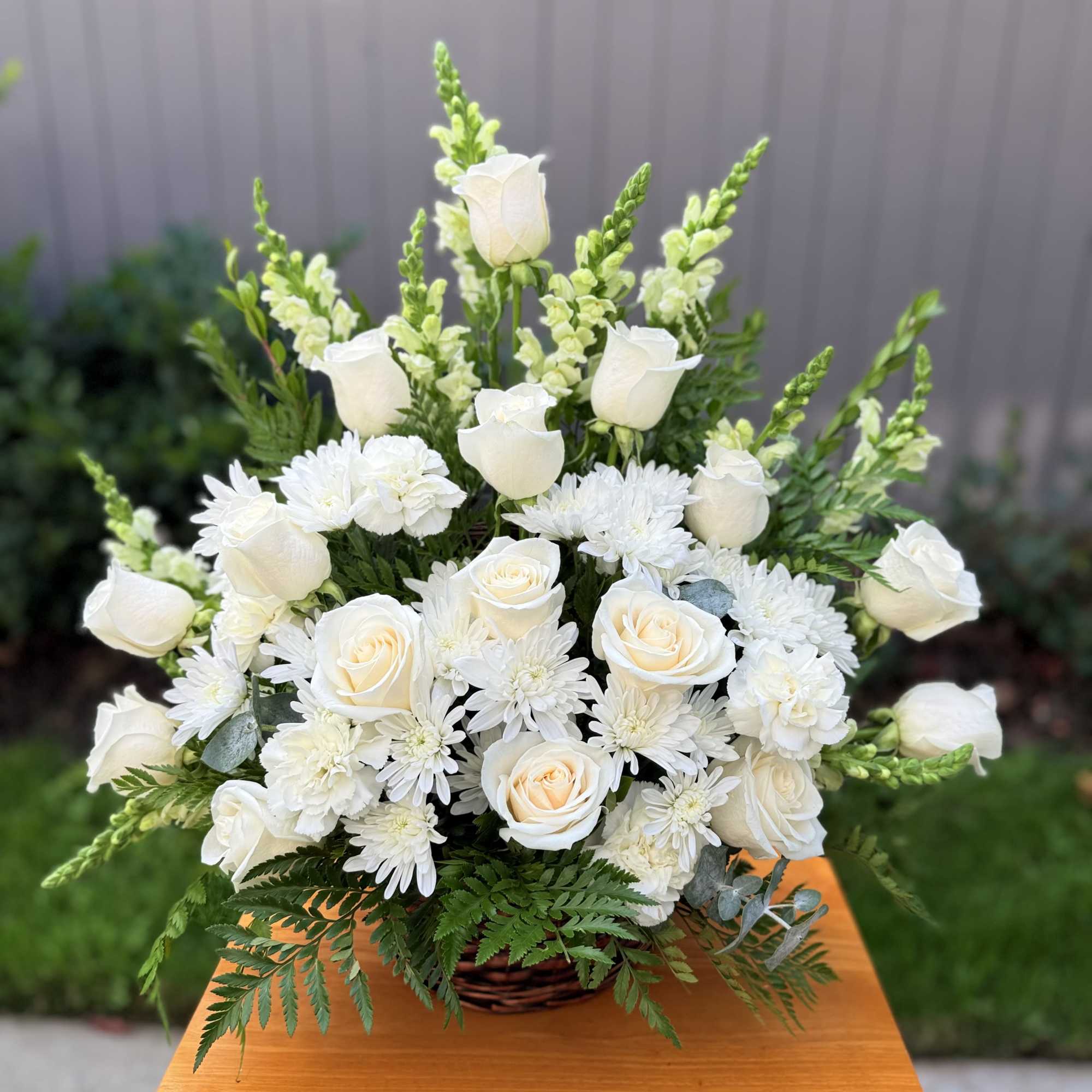 Express your deepest sympathies with this beautiful arrangement that radiates peace; it&rsquo;s
