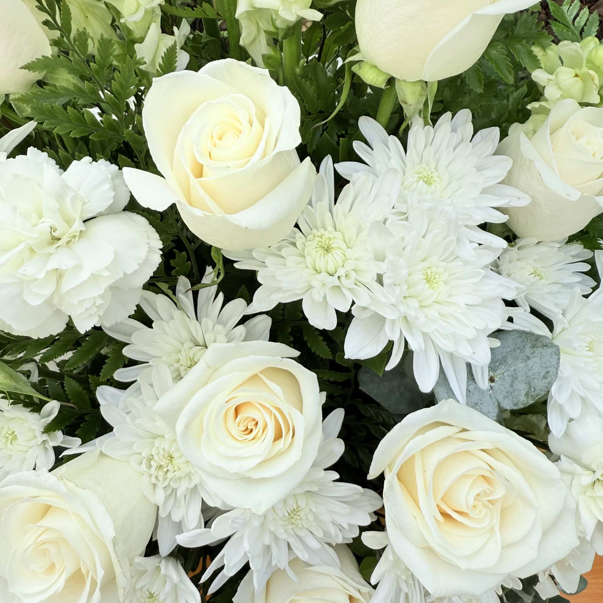 Express your deepest sympathies with this beautiful arrangement that radiates peace; it&rsquo;s