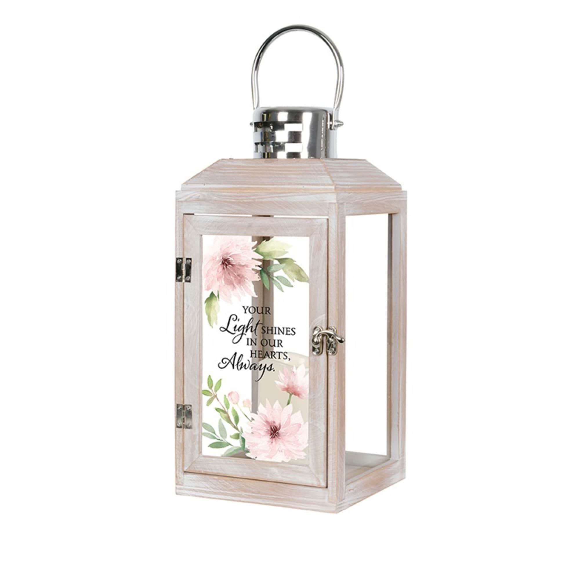 This decorative keepsake lantern reads "Your light shines in our hearts always".