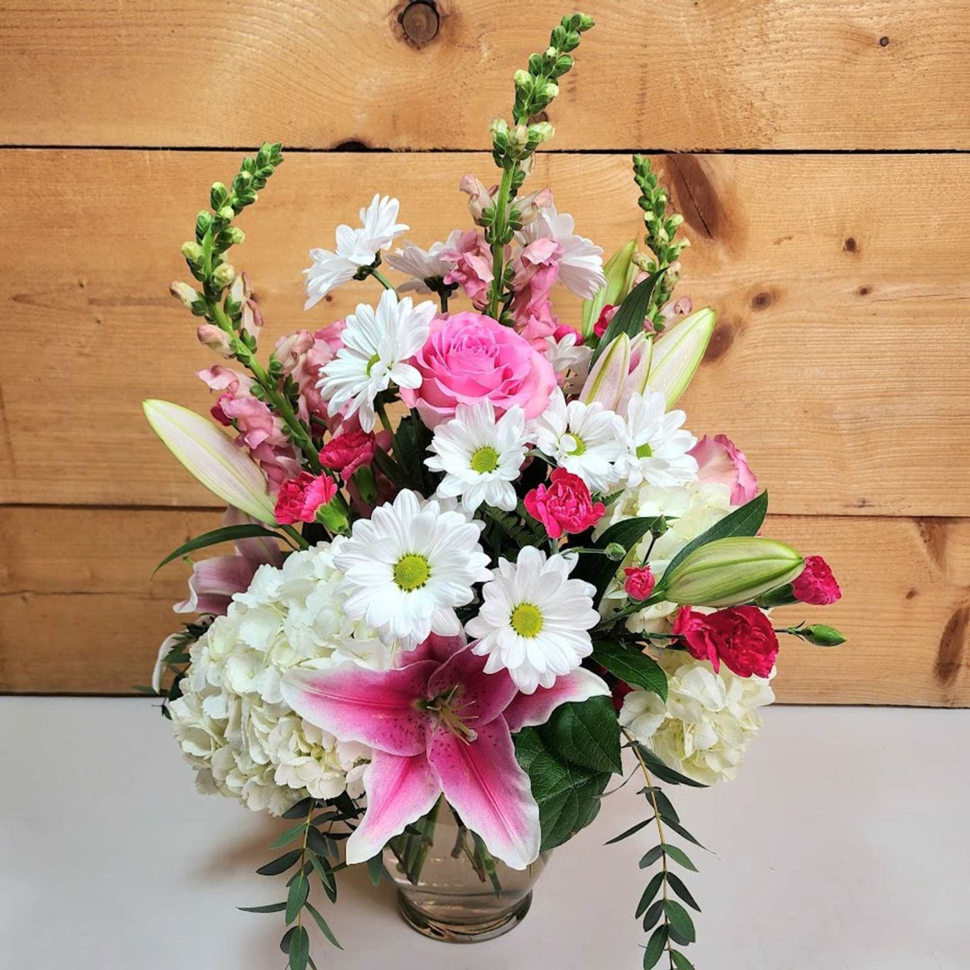 Blooms of Beauty is a captivating floral arrangement that radiates elegance and