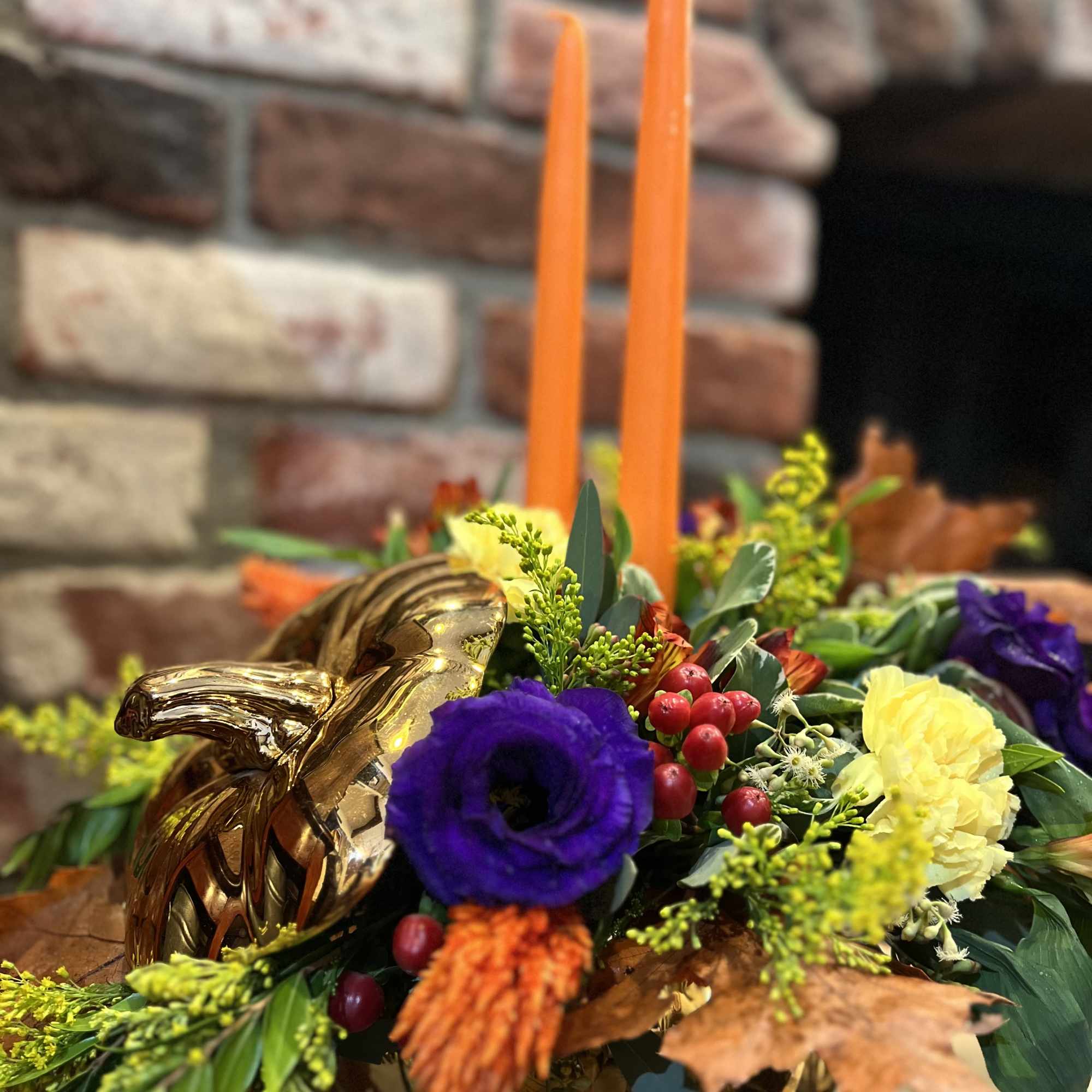 This golden pumpkin arrangement with it&#039;s deep purple lisianthus, orange celosia, red