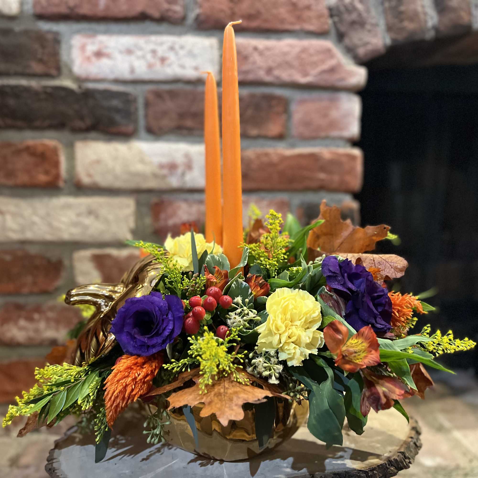 This golden pumpkin arrangement with it&#039;s deep purple lisianthus, orange celosia, red
