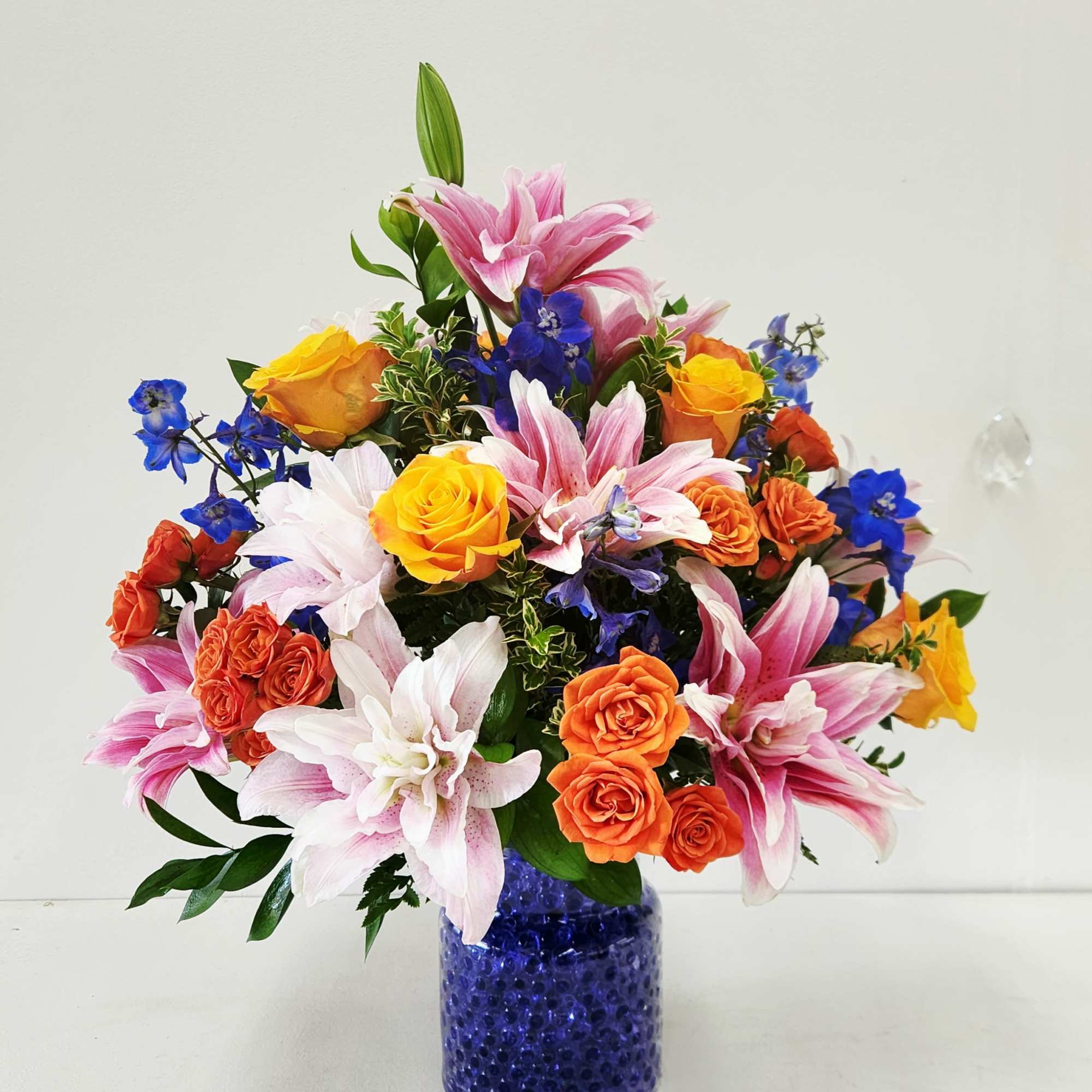 Turn heads with this show-stopping bouquet bursting with vibrant orange, pink, and