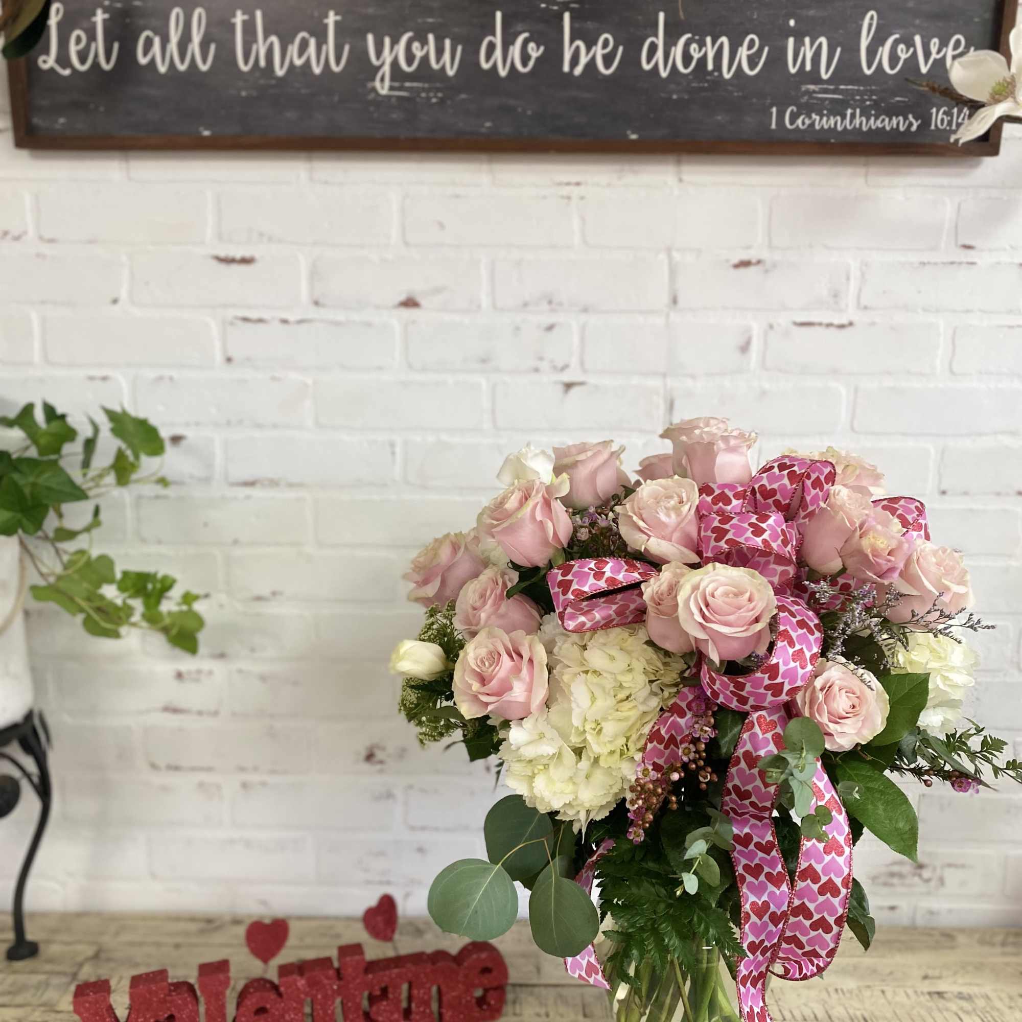 Over a dozen pink mondial roses with hydrangea and filler flowers