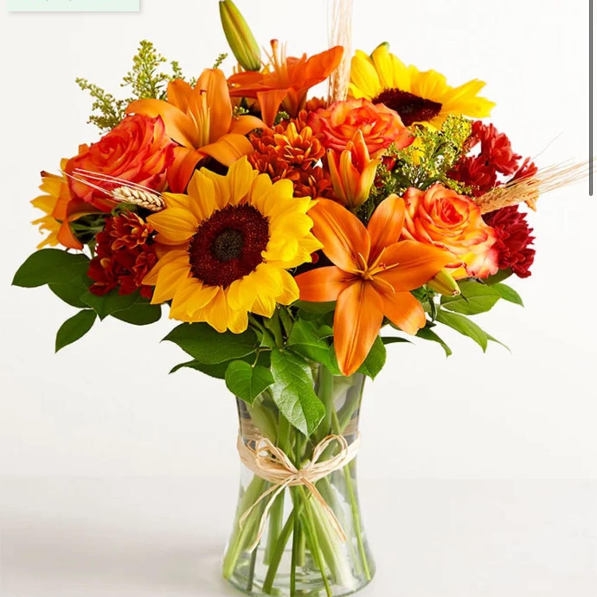 All-around arrangement with sunflowers, autumn-color roses, sunflowers, orange Asiatic lilies, and red