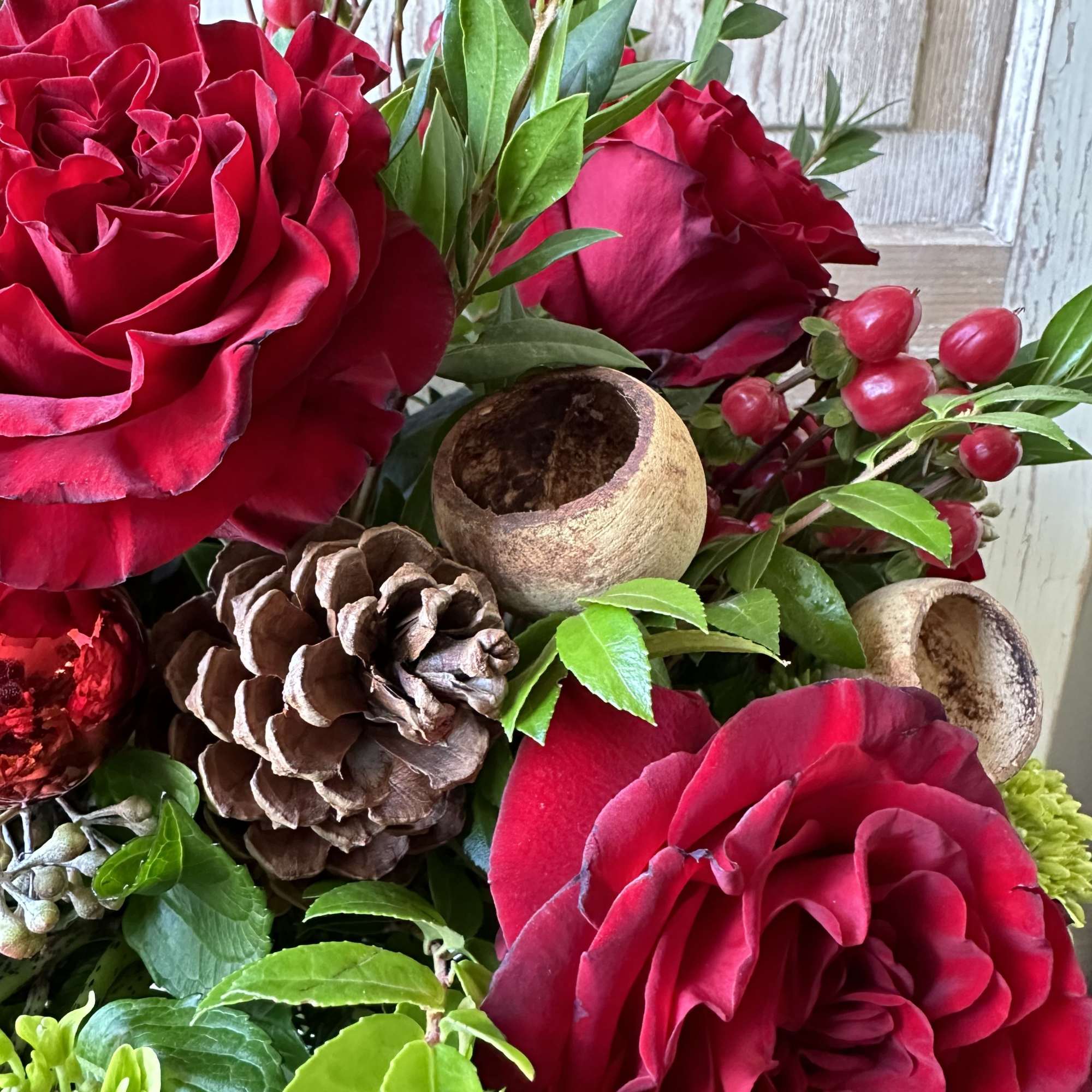 Warm up any home with this festive holiday arrangement! Seasonal fragrant greens