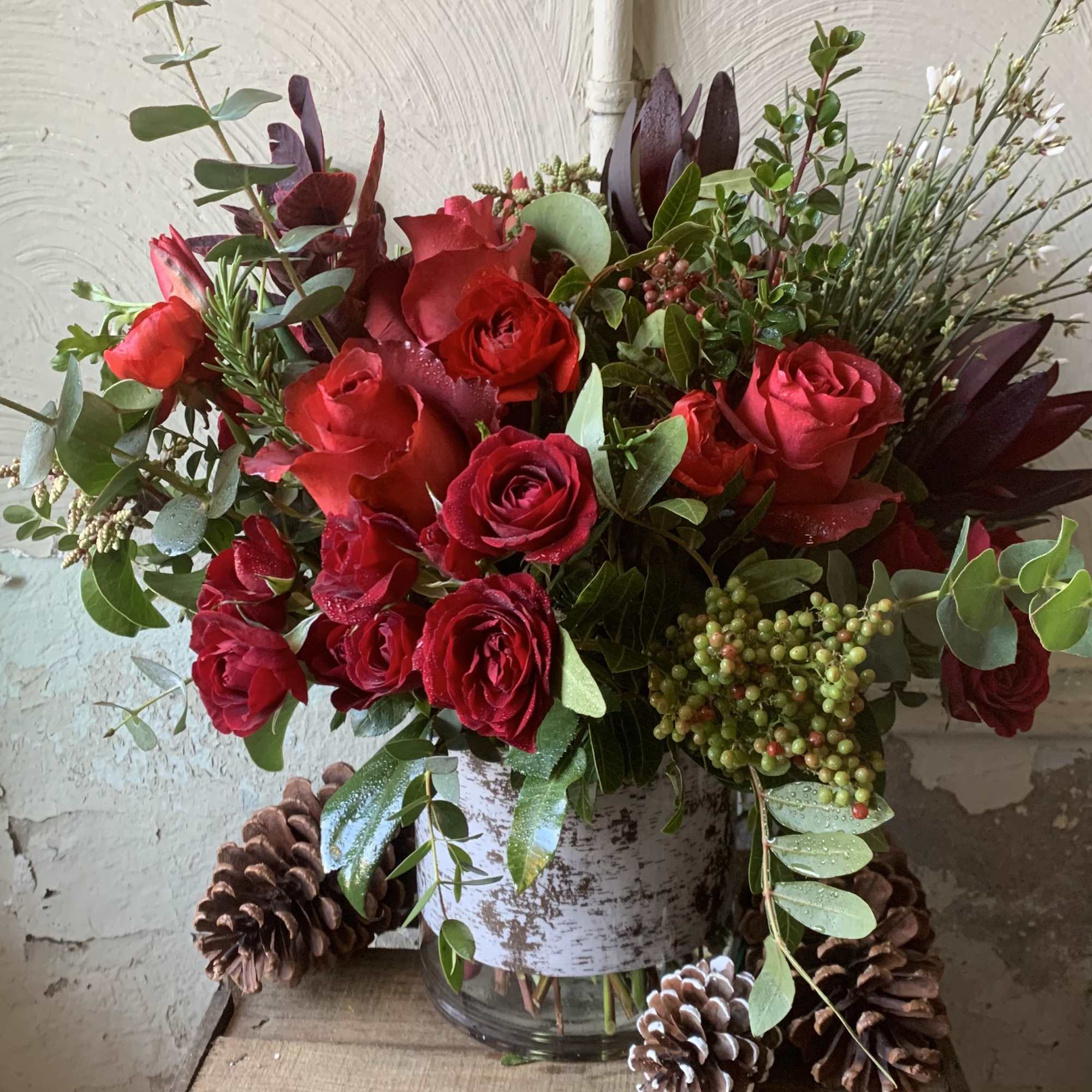 Spread Holiday cheer with this beautiful array of seasonal red roses and