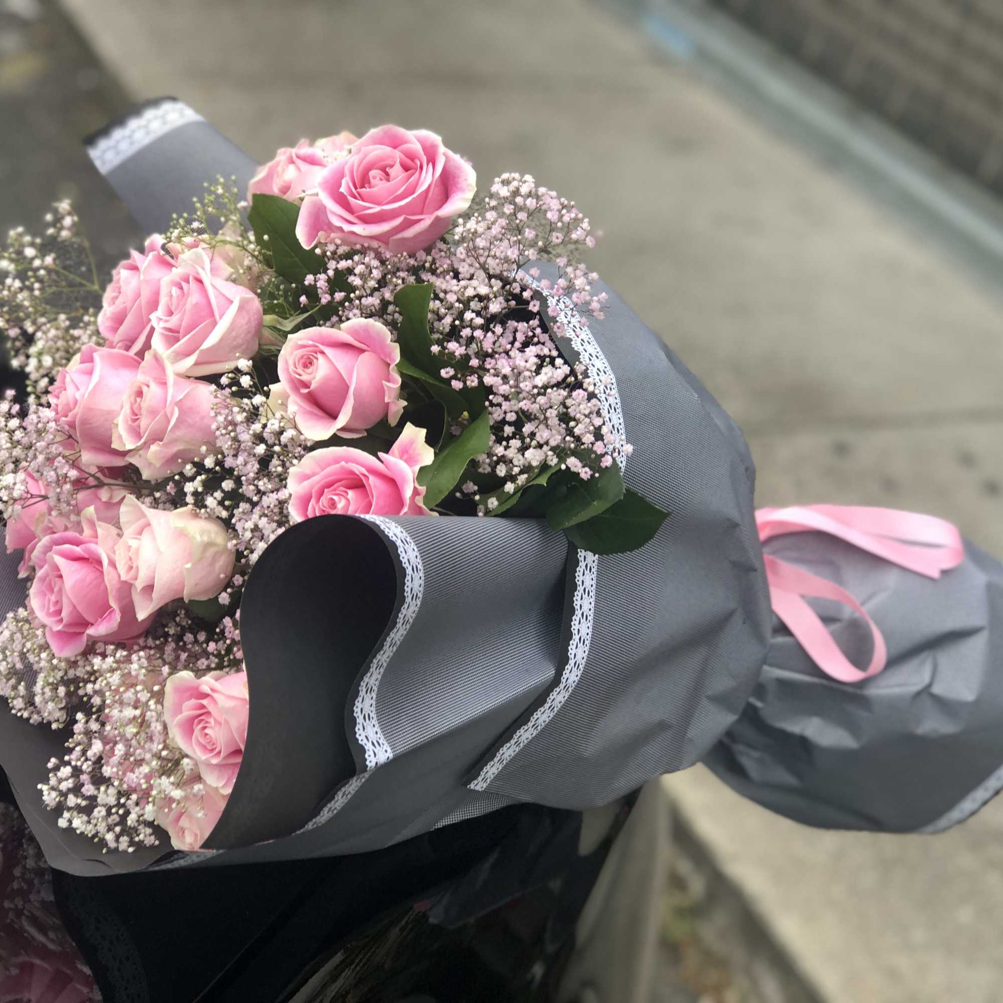12 pink roses with babies breath wrapped beautifully 
