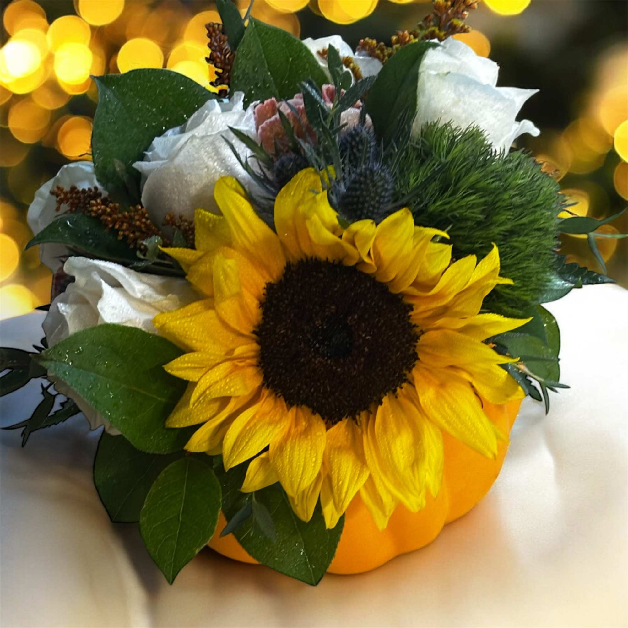 This delightful arrangement  is beautifully presented in a charming white pumpkin