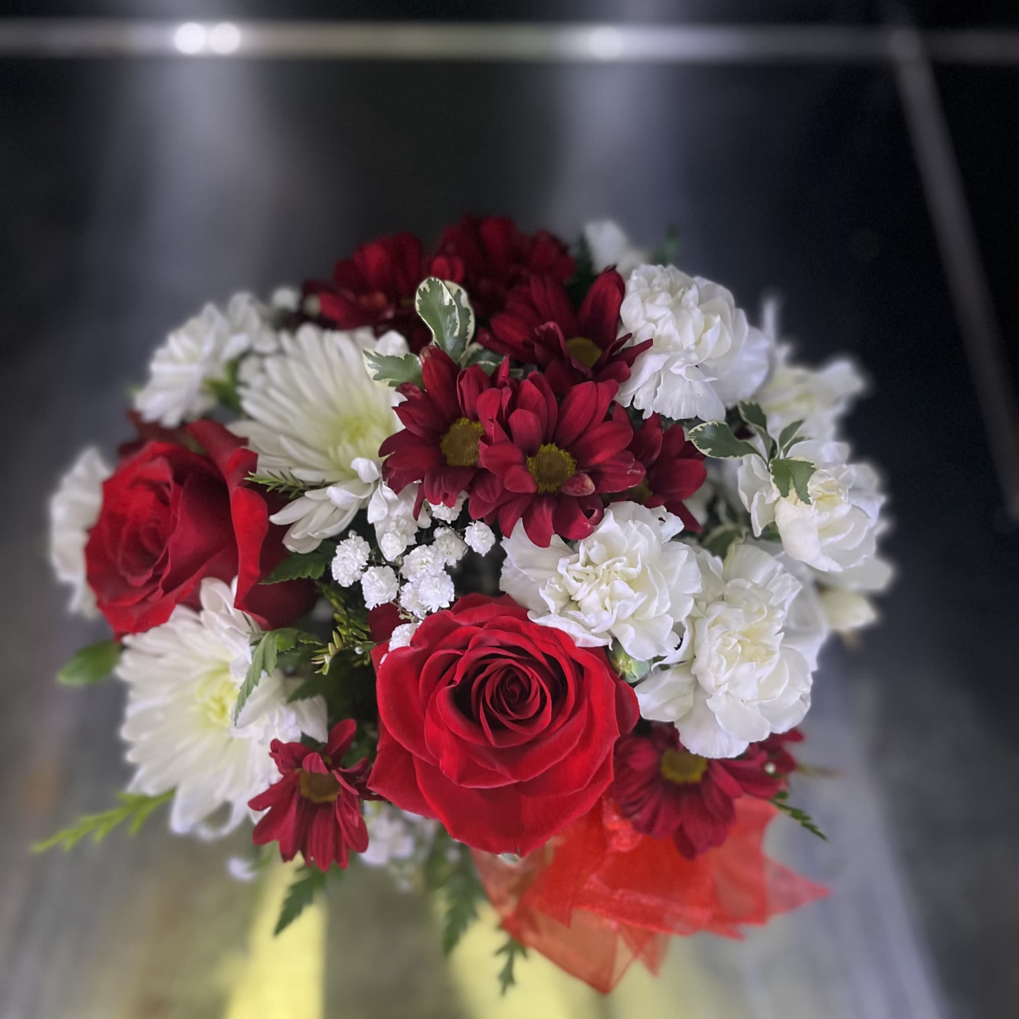 Fresh flowers in red cube 